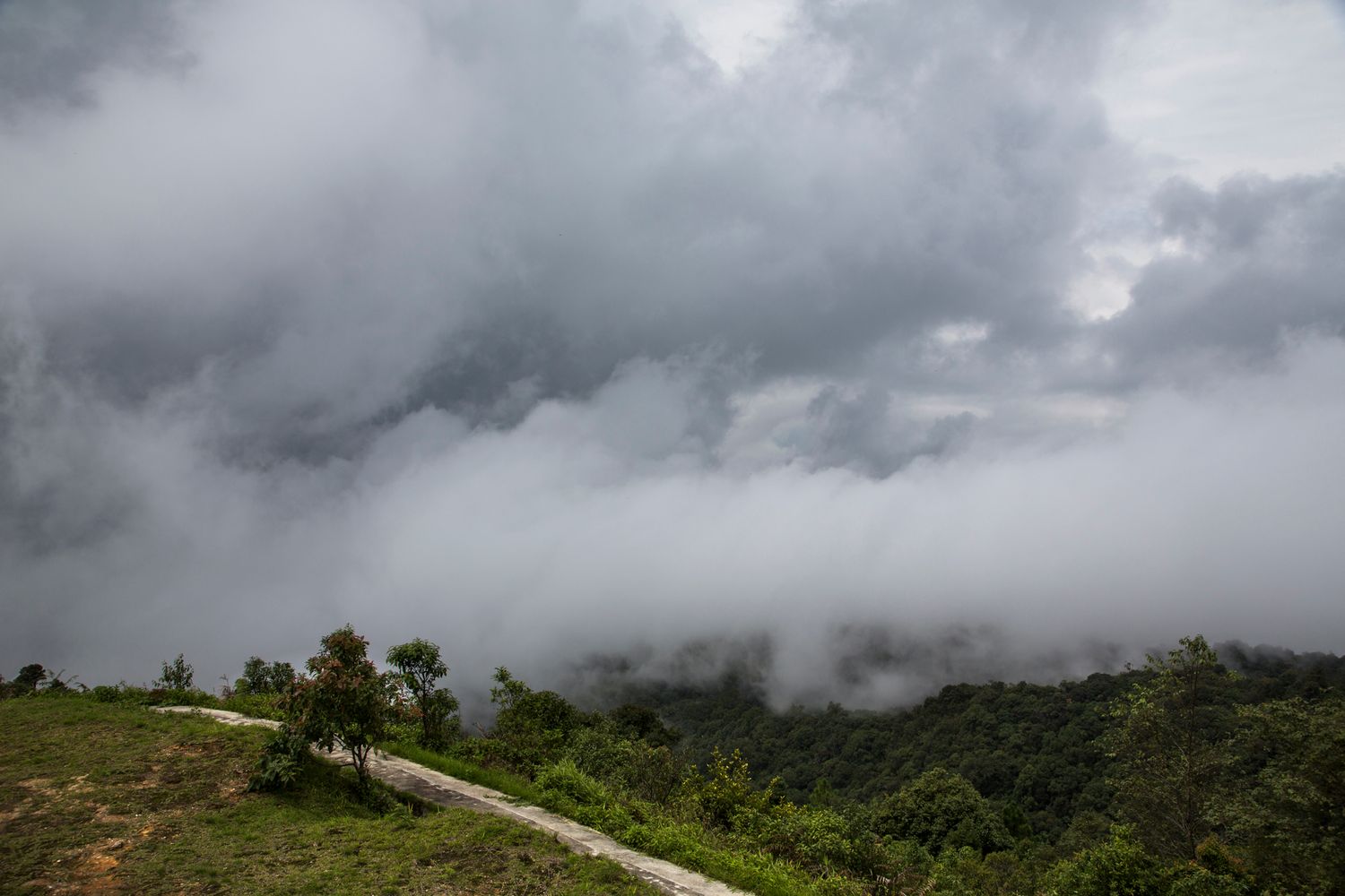 Dramatic mountain landscape shrouded in dark storm clouds.