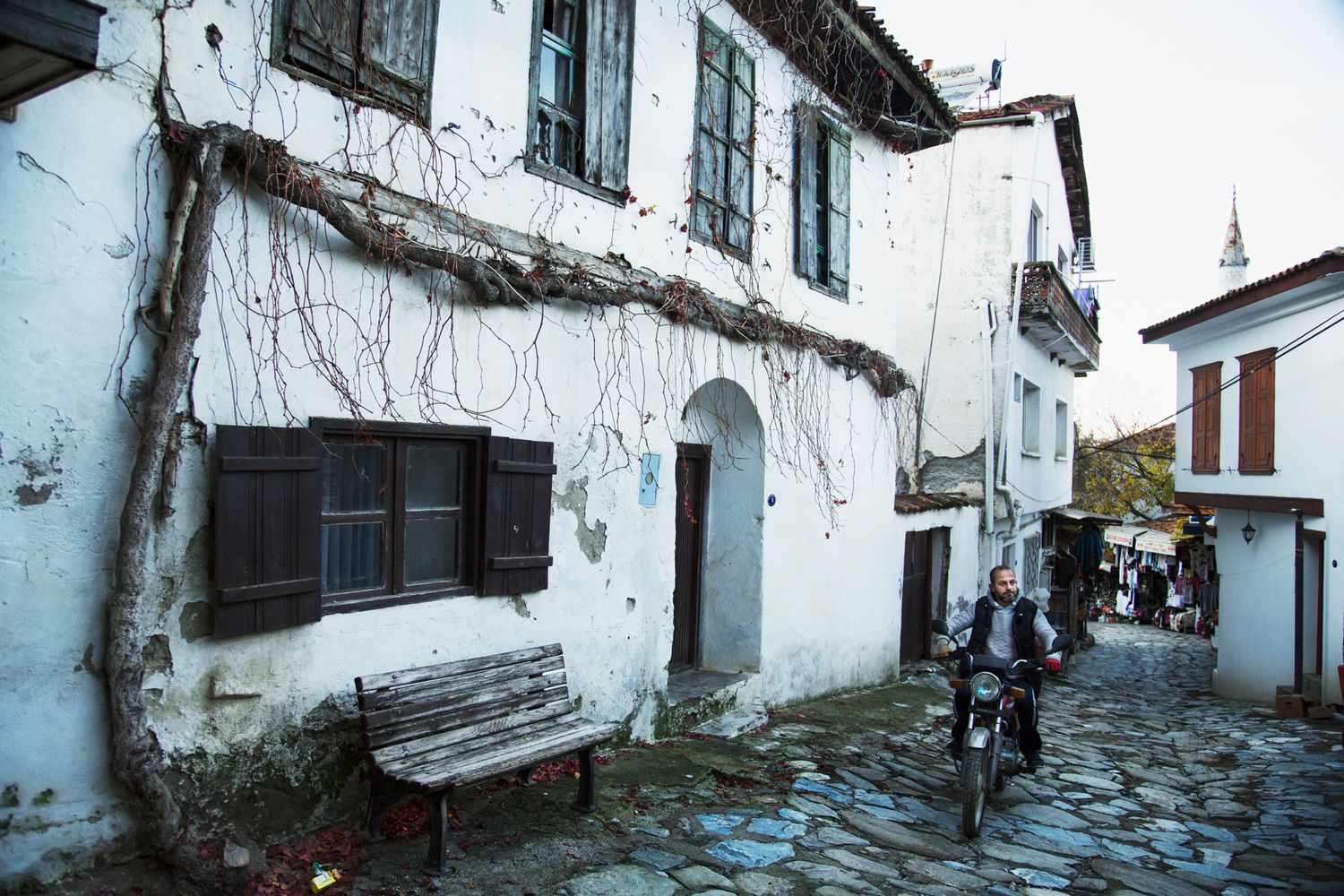 Traditional whitewashed buildings with stone pathways in a historic Mediterranean village.