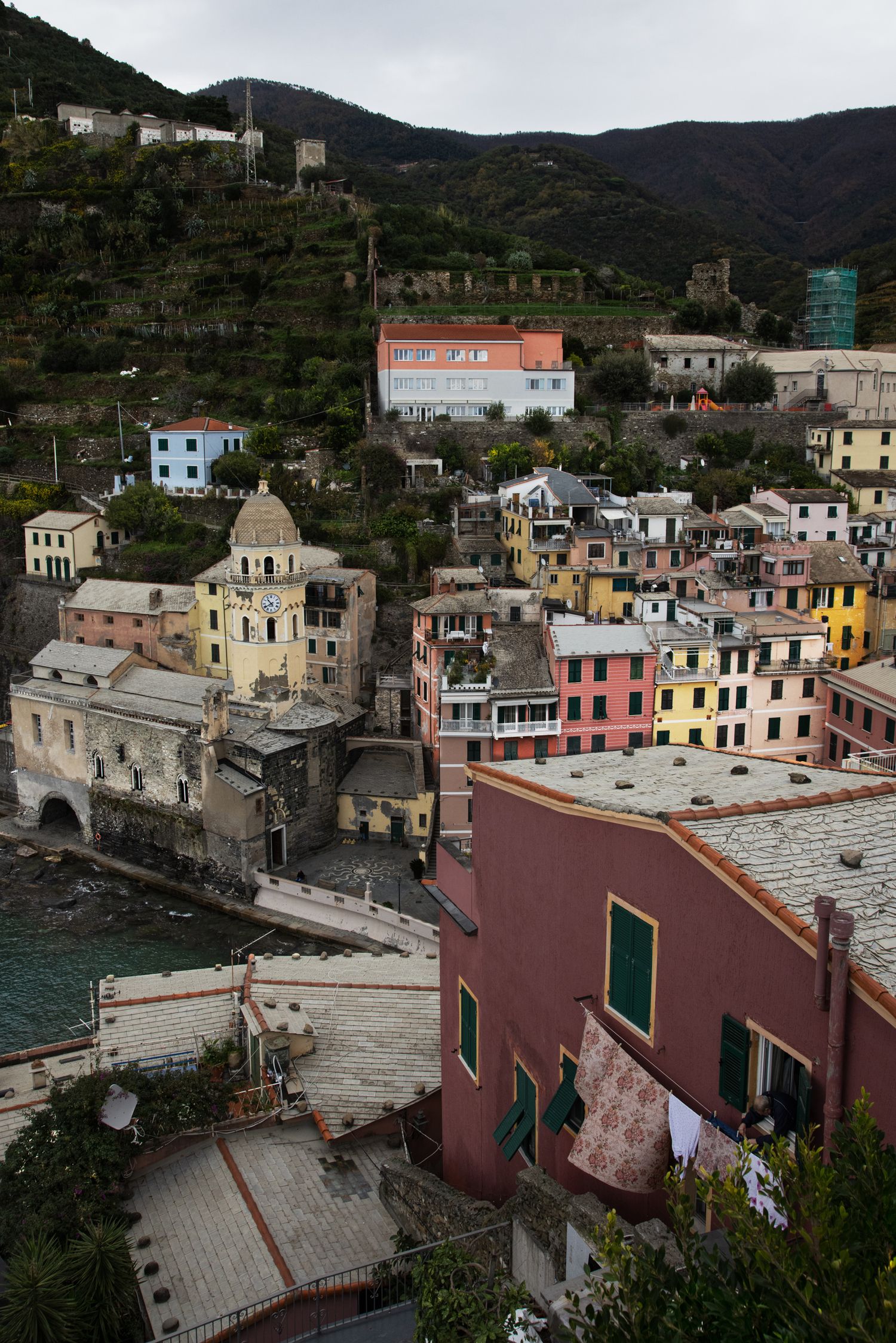 Colorful buildings of Vernazza village in Cinque Terre, Italy, nestled on a hillside overlooking the sea.