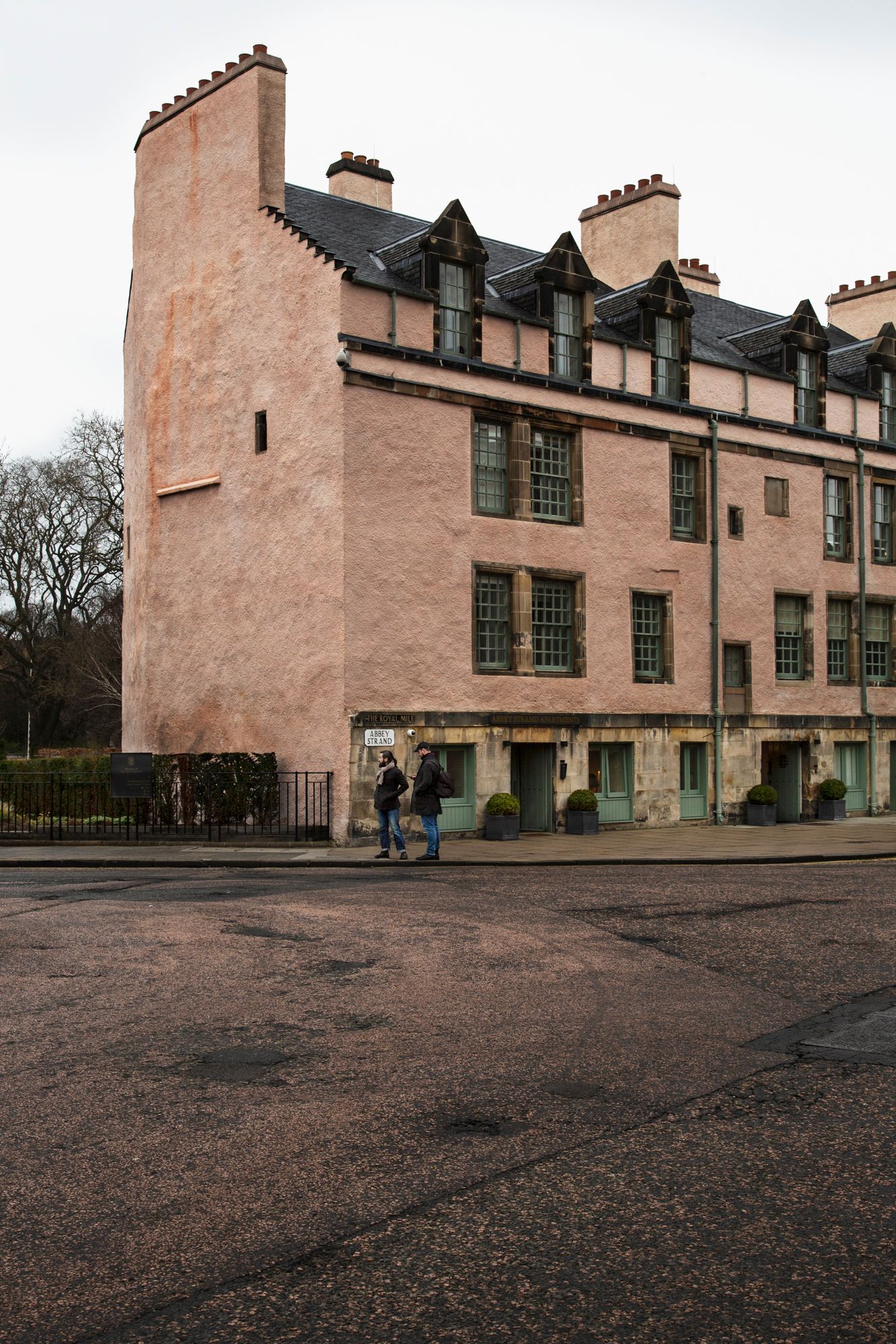 The historic Hill House in Scotland features pink-colored walls and distinctive architectural elements in a series of exterior views.