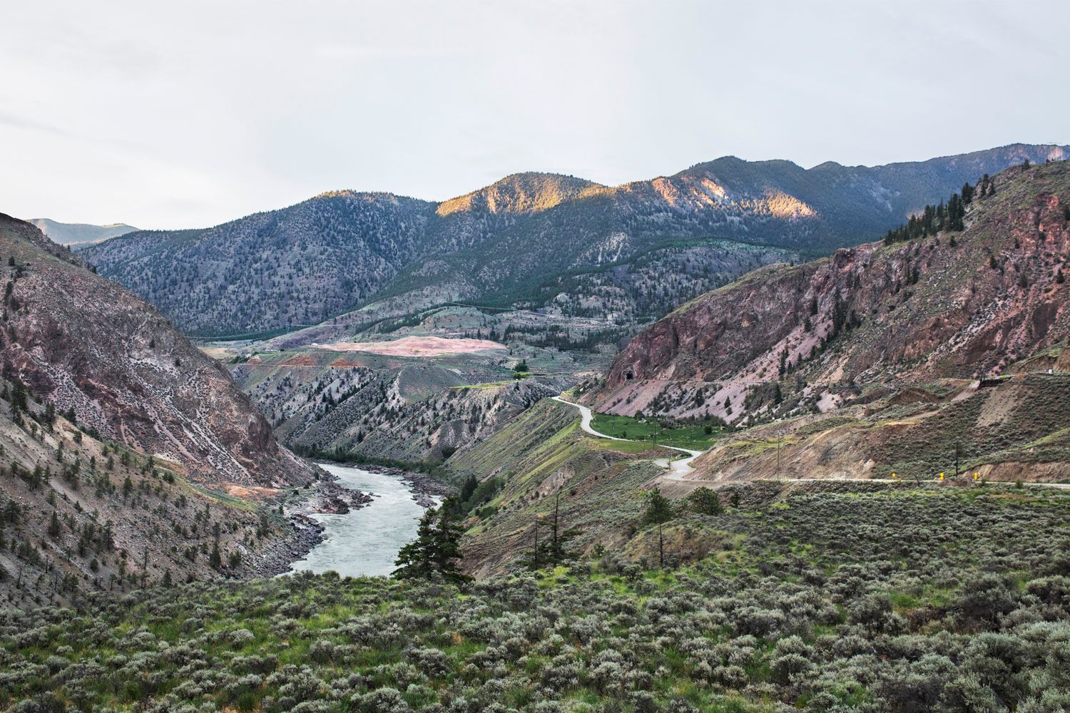 Scenic mountain valley with winding river and arid slopes in British Columbia's interior.