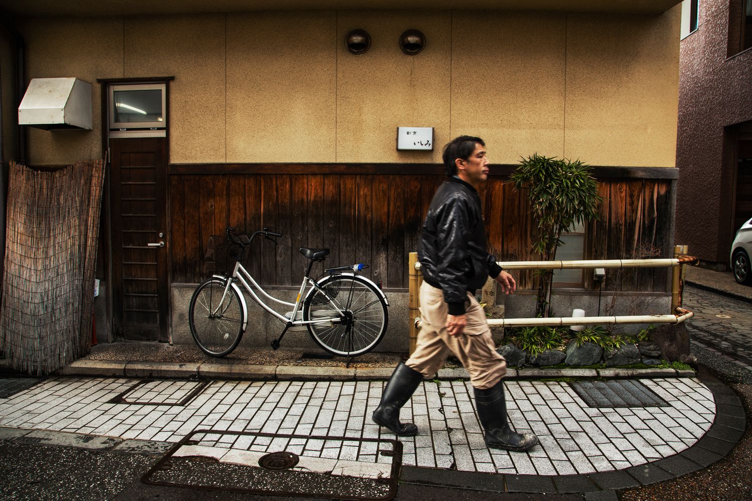 Narrow street scene in historic Japanese neighborhood with traditional architecture.