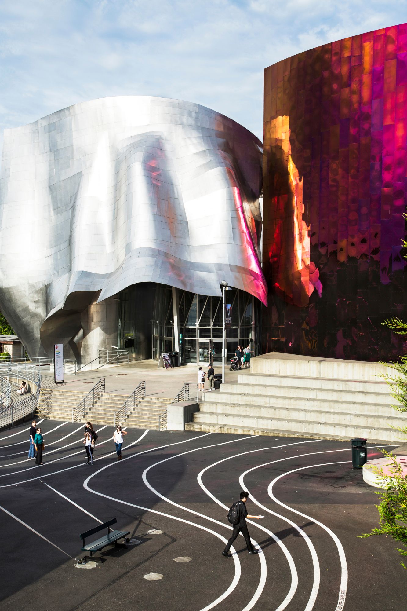 Modern architectural building with curved metallic surfaces and curved walkways in Seattle.