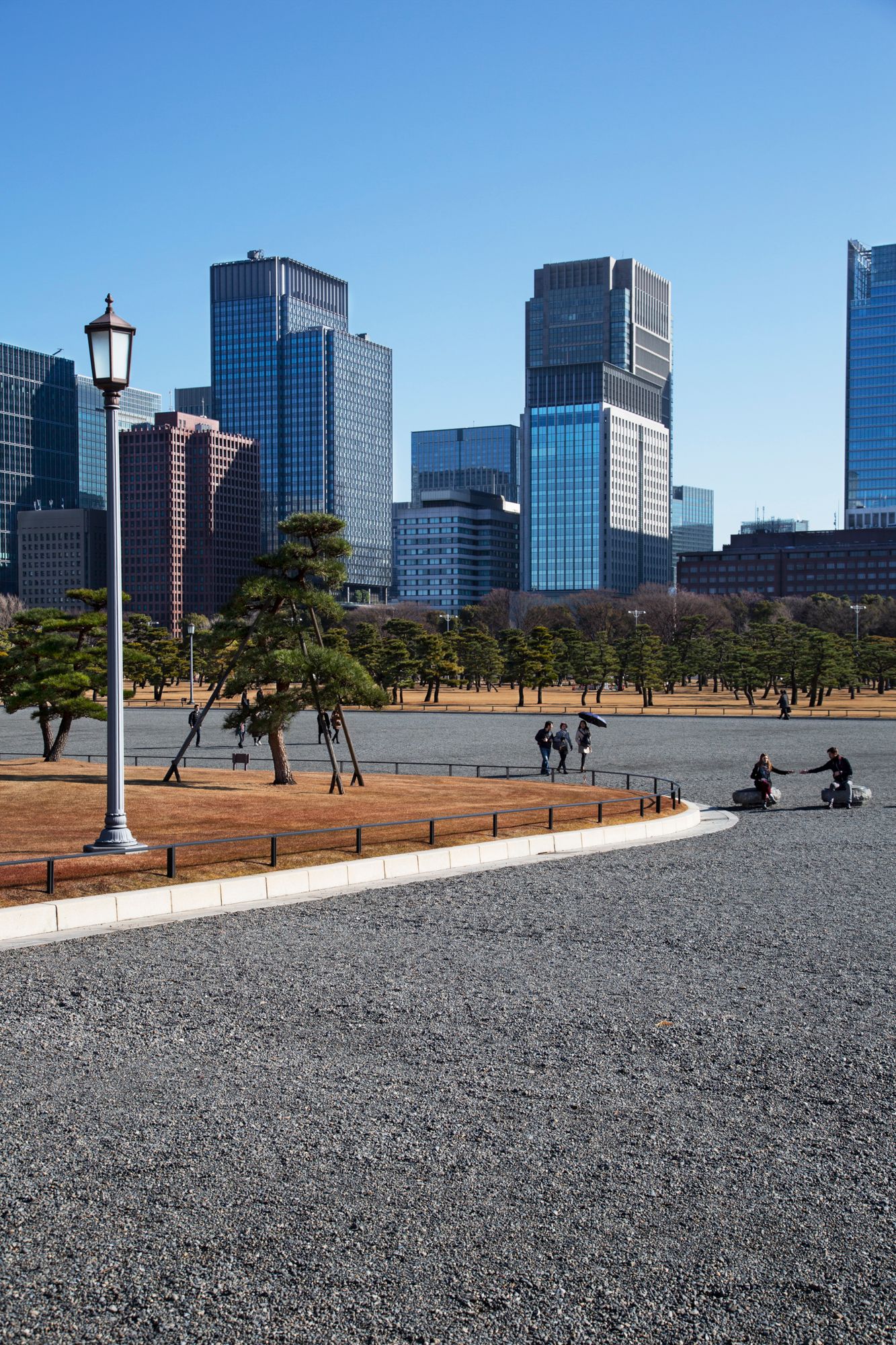 Modern office buildings line the grounds of the Imperial Palace in Tokyo.