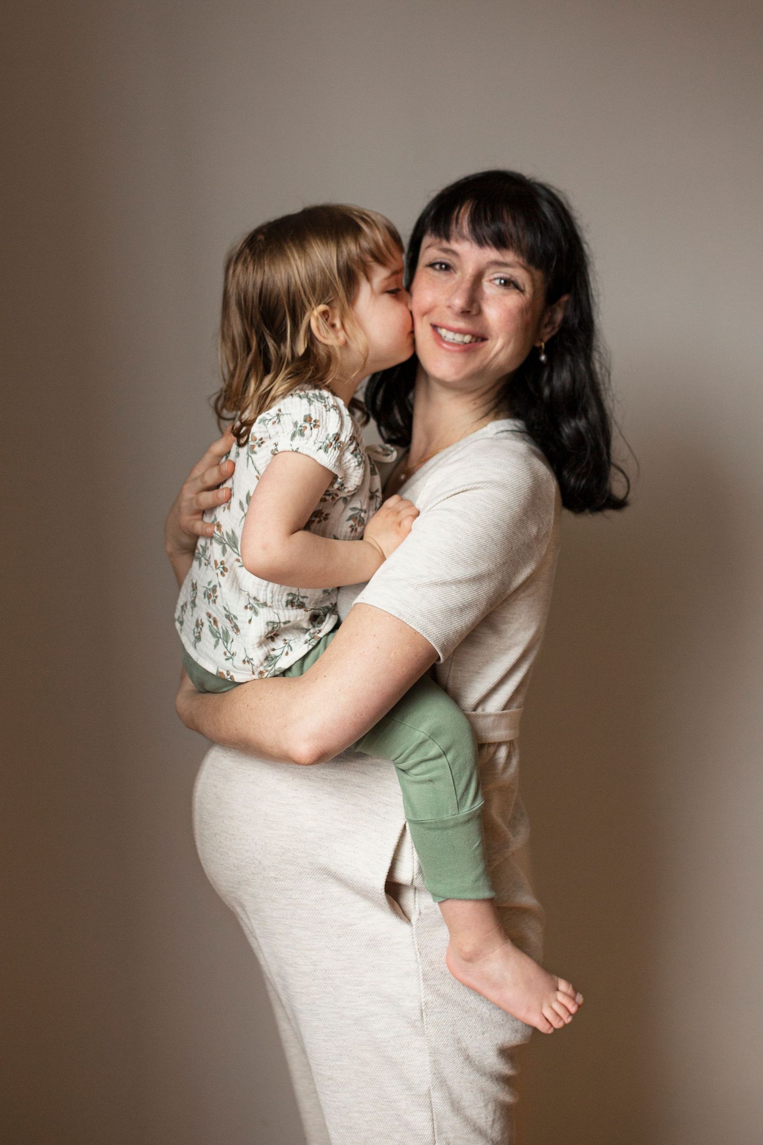 Parent and child sharing tender embrace in casual home setting.