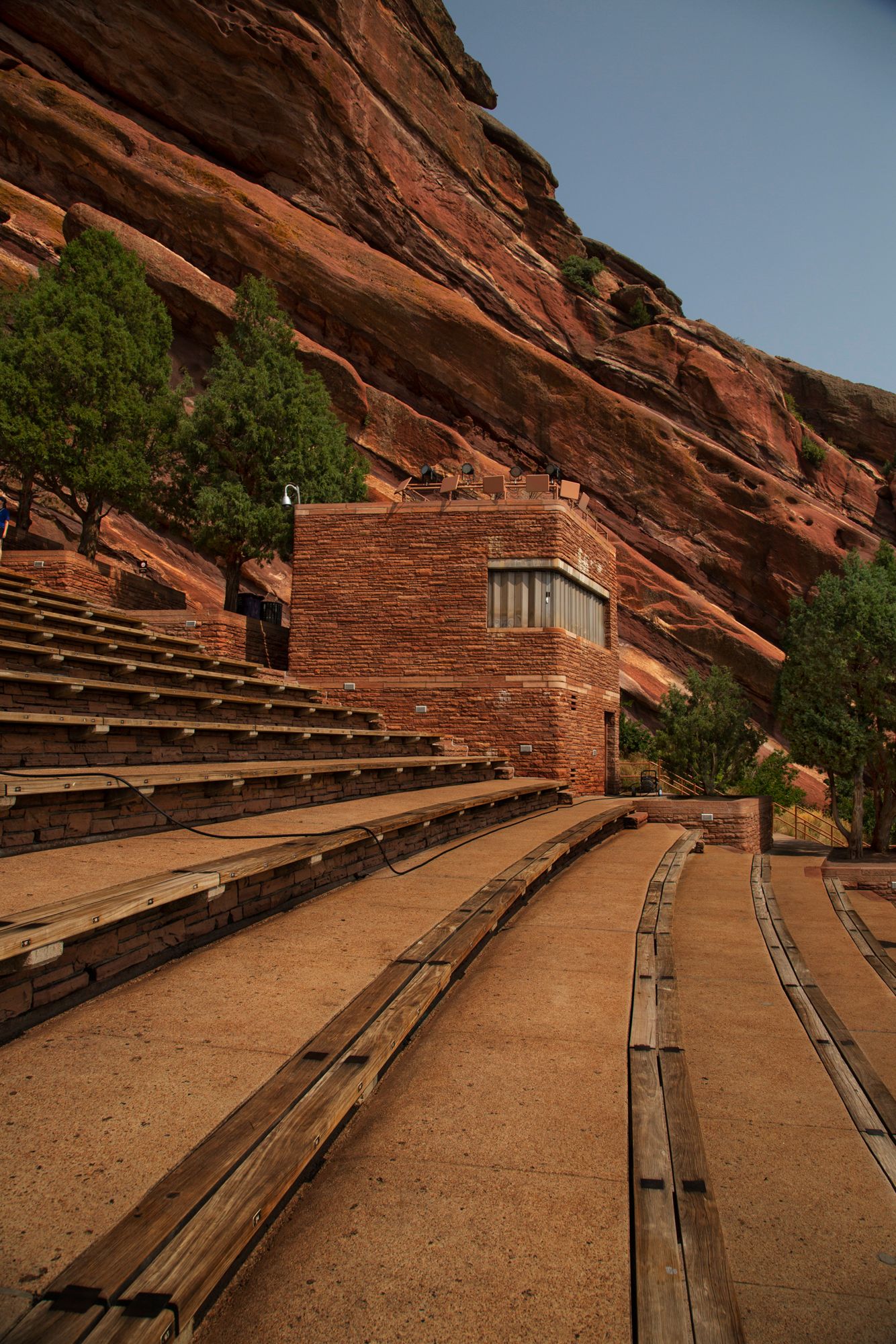 Red Rocks Amphitheatre's iconic wooden bench seating and sandstone formations create a natural outdoor concert venue in Colorado.