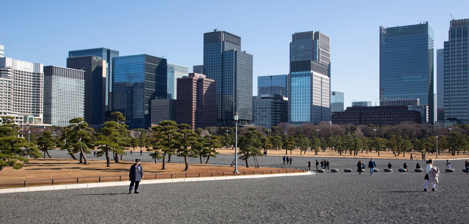 Wide panoramic view of Tokyo skyline with modern office buildings and parks.
