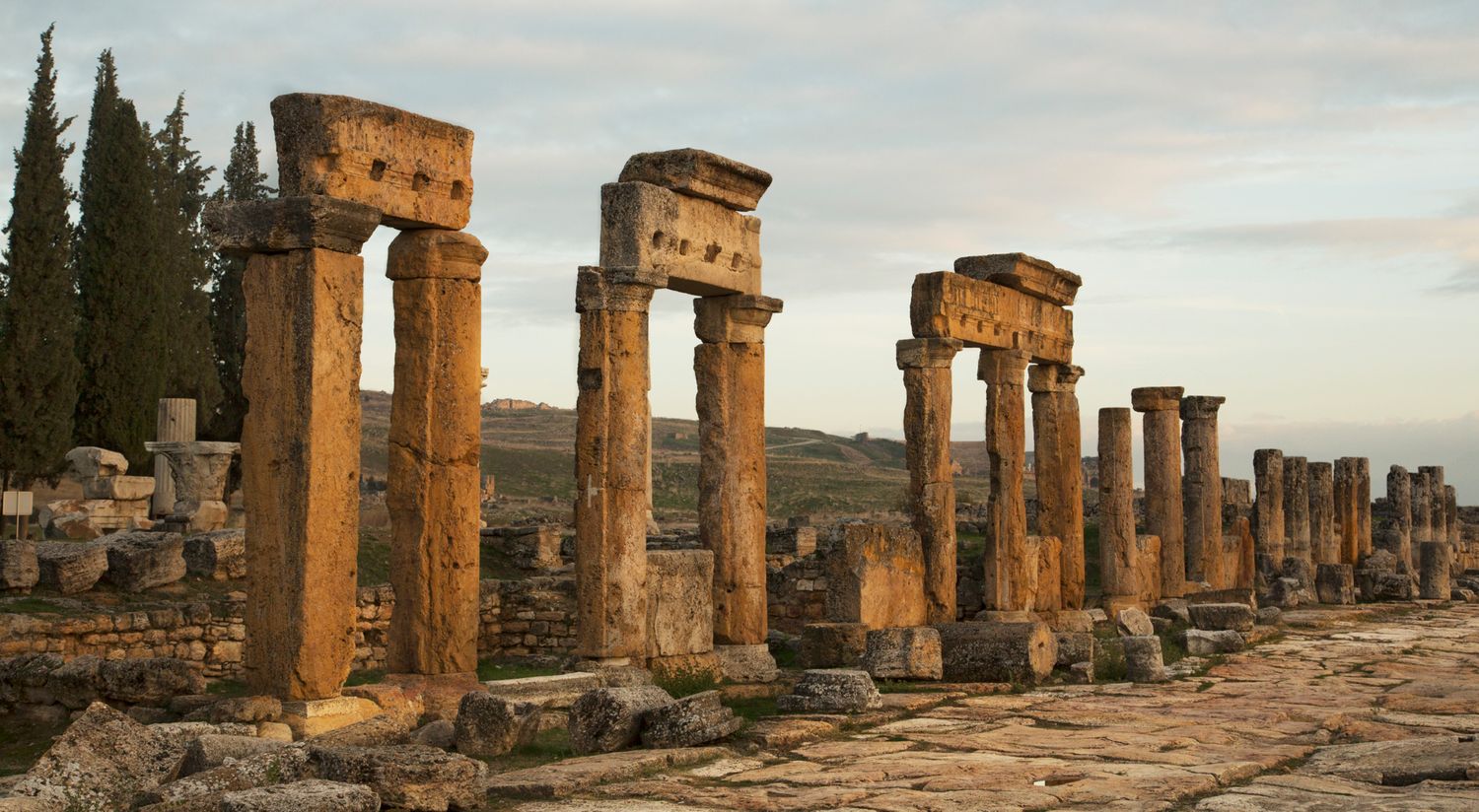 Row of ancient Roman columns at sunset in Hierapolis archaeological site, Turkey.