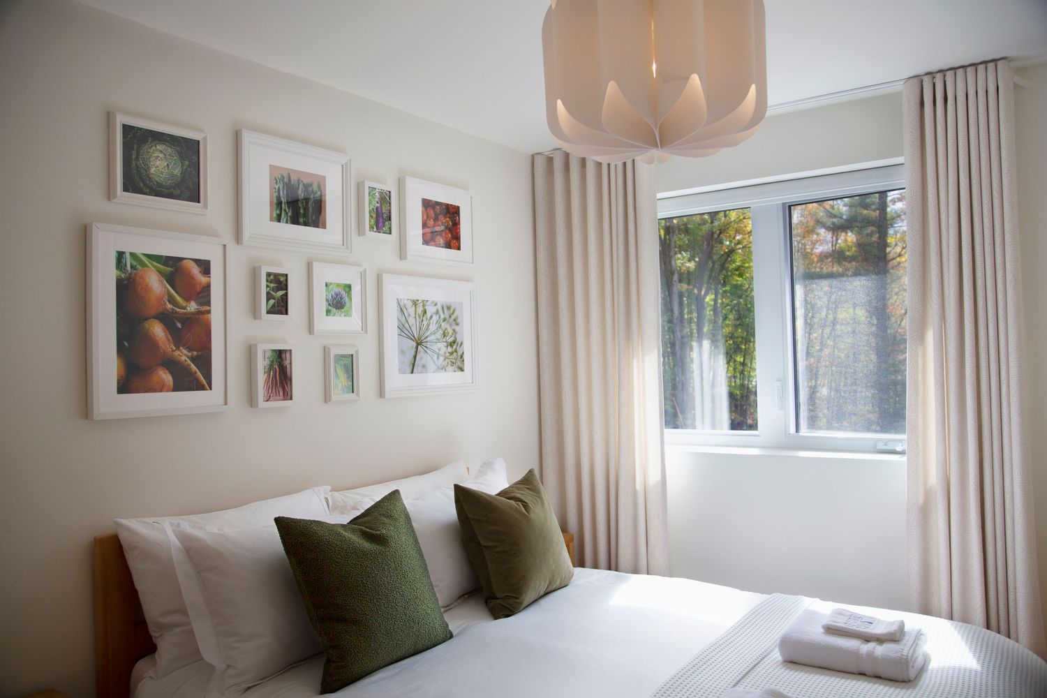 Bright modern bedroom interior with white walls and nature-inspired decor.