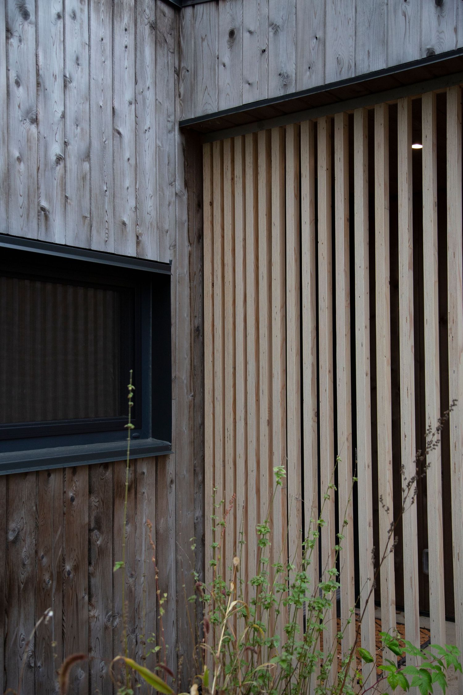 Architectural detail showing vertical wooden slats on modern building exterior.