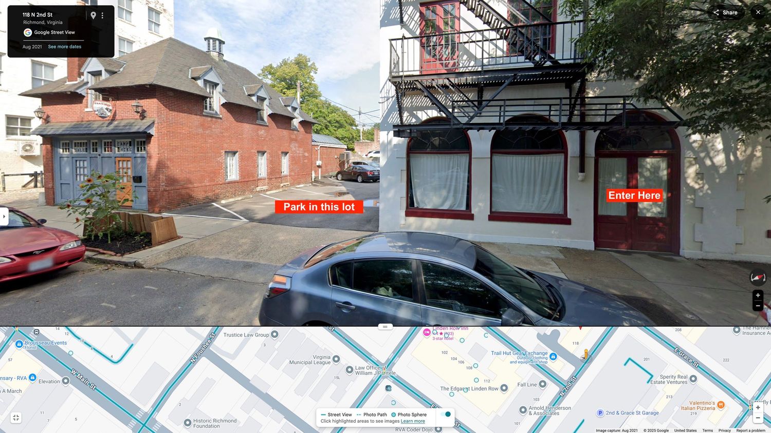 Street view of urban brick buildings with a parking lot and retail spaces, overlaid with a map showing the location.