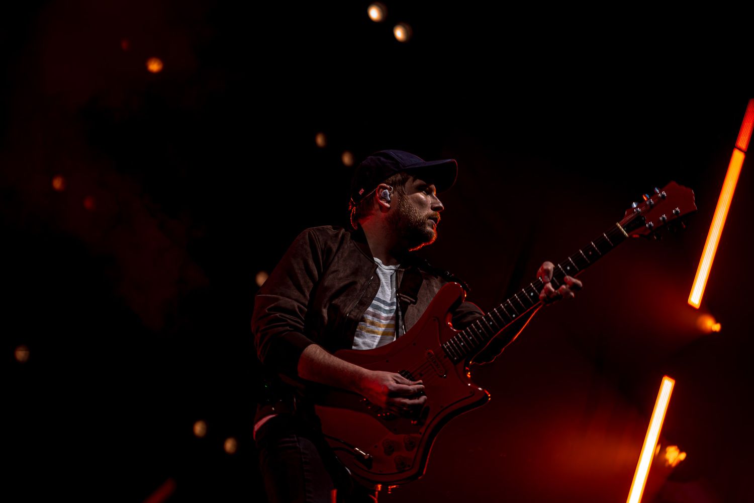 Patrick Stump with guitar and red background