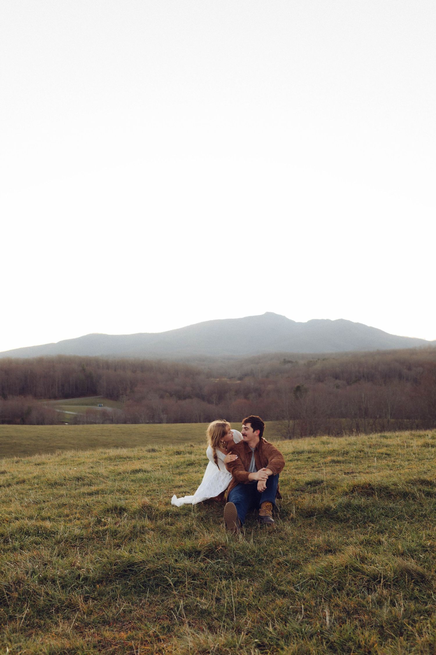 Scenic mountain landscape view with rolling hills and meadows at dusk.