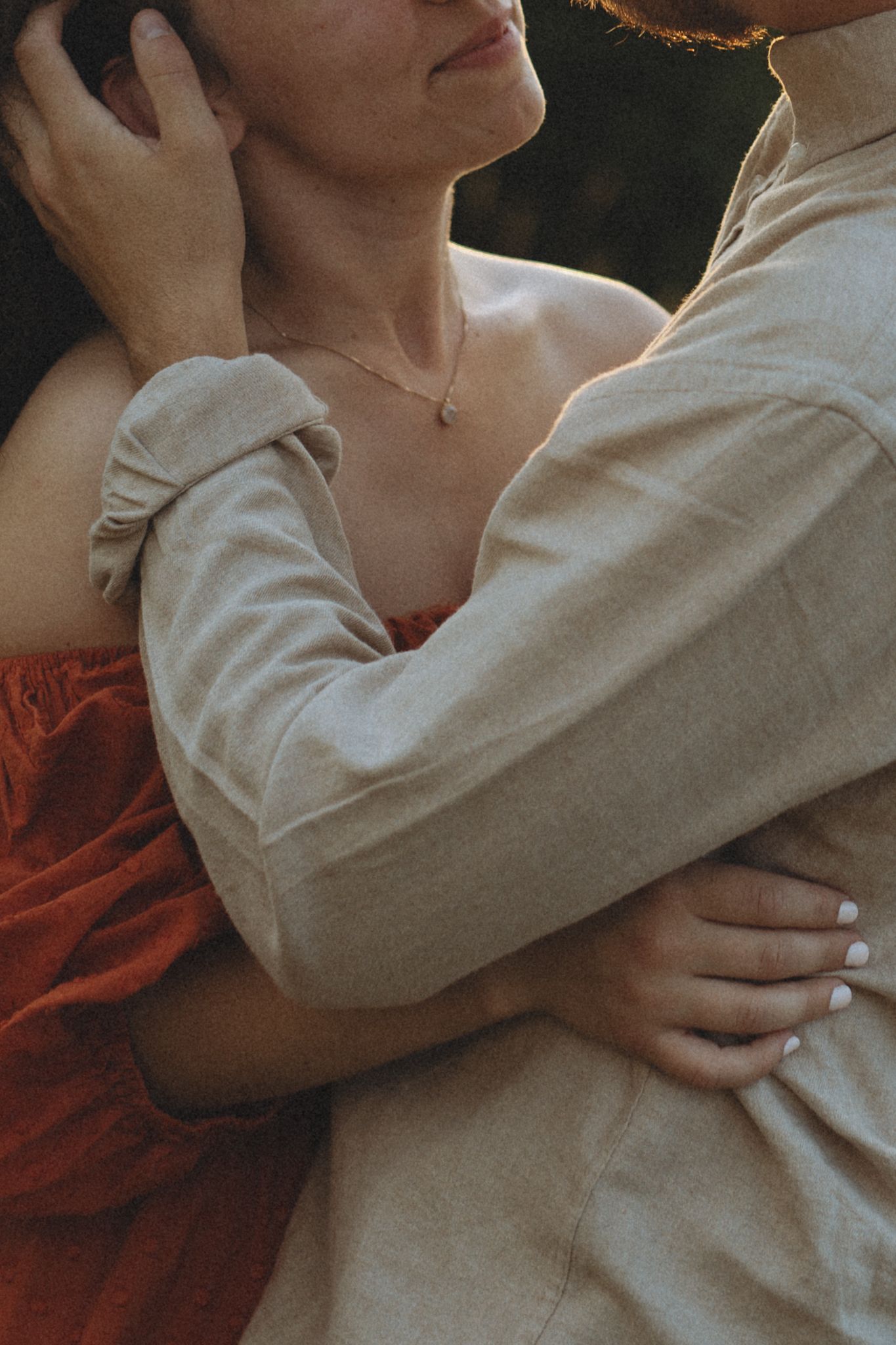 An intimate moment captured in warm tones showing gentle embracing figures.