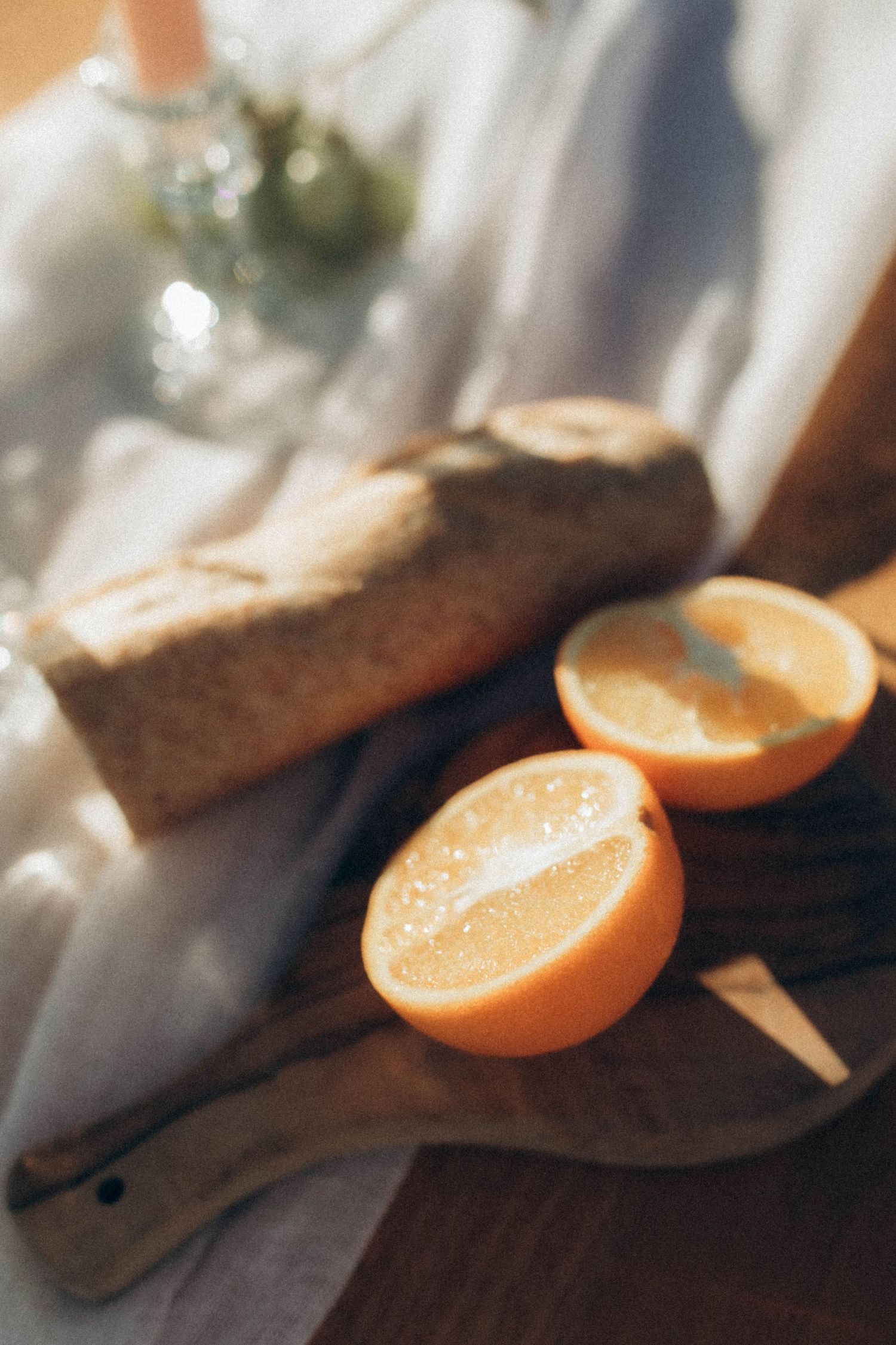 Sliced oranges arranged on a wooden surface in warm natural lighting.
