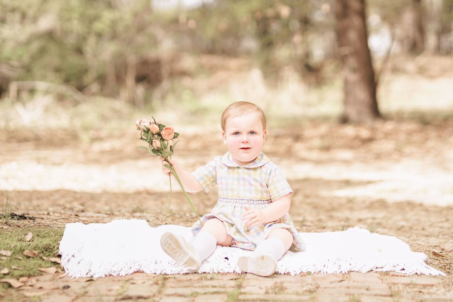 Child interacting with bunny during portrait session in South Carolina, soft natural light, whimsical heirloom style