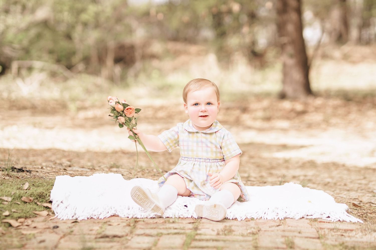 Child interacting with bunny during portrait session in South Carolina, soft natural light, whimsical heirloom style