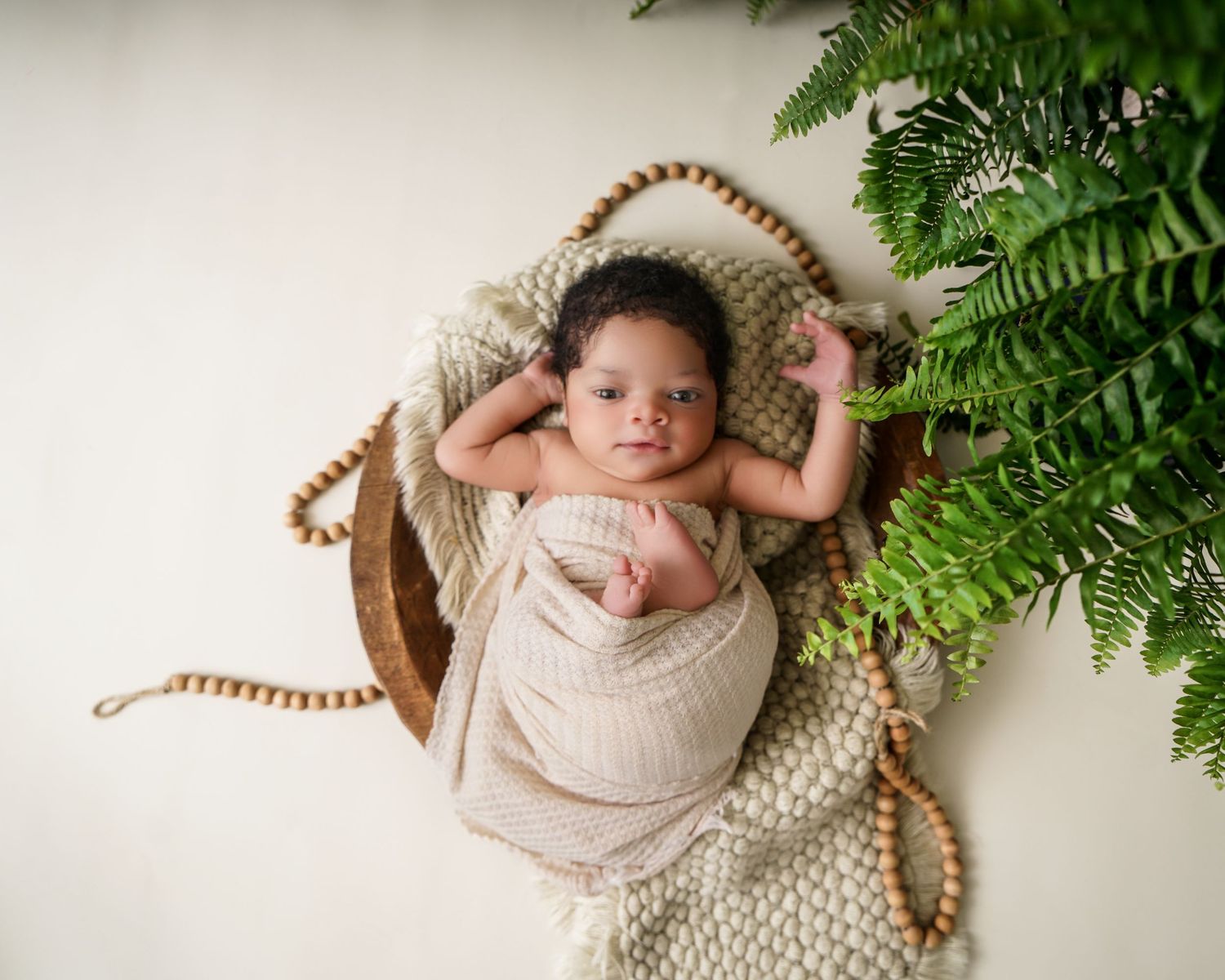 Newborn baby portrait in South Carolina, soft natural light, cozy wrapped infant photography, timeless heirloom style