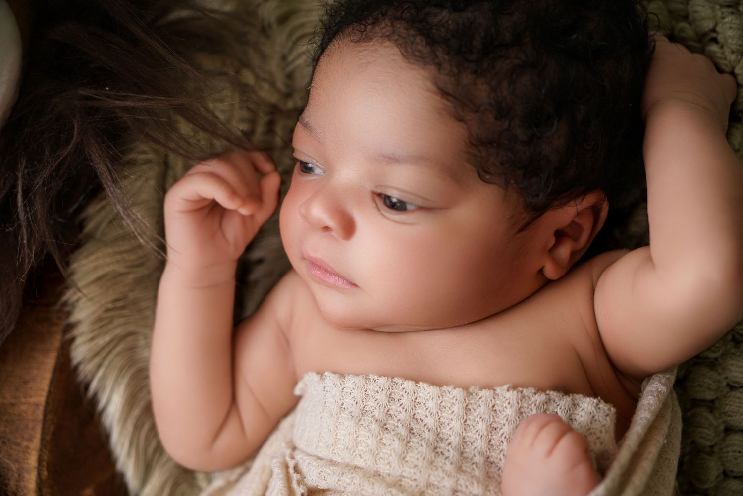 Newborn baby portrait in South Carolina, soft natural light, cozy wrapped infant photography, timeless heirloom style