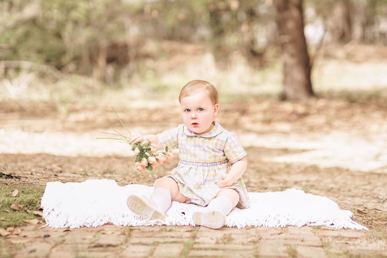 Child interacting with bunny during portrait session in South Carolina, soft natural light, whimsical heirloom style