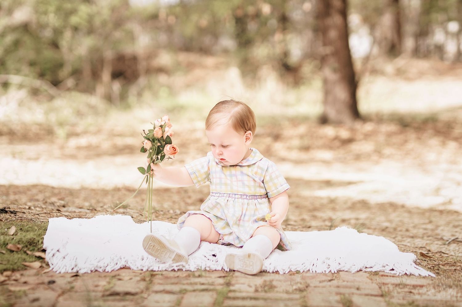 Child interacting with bunny during portrait session in South Carolina, soft natural light, whimsical heirloom style