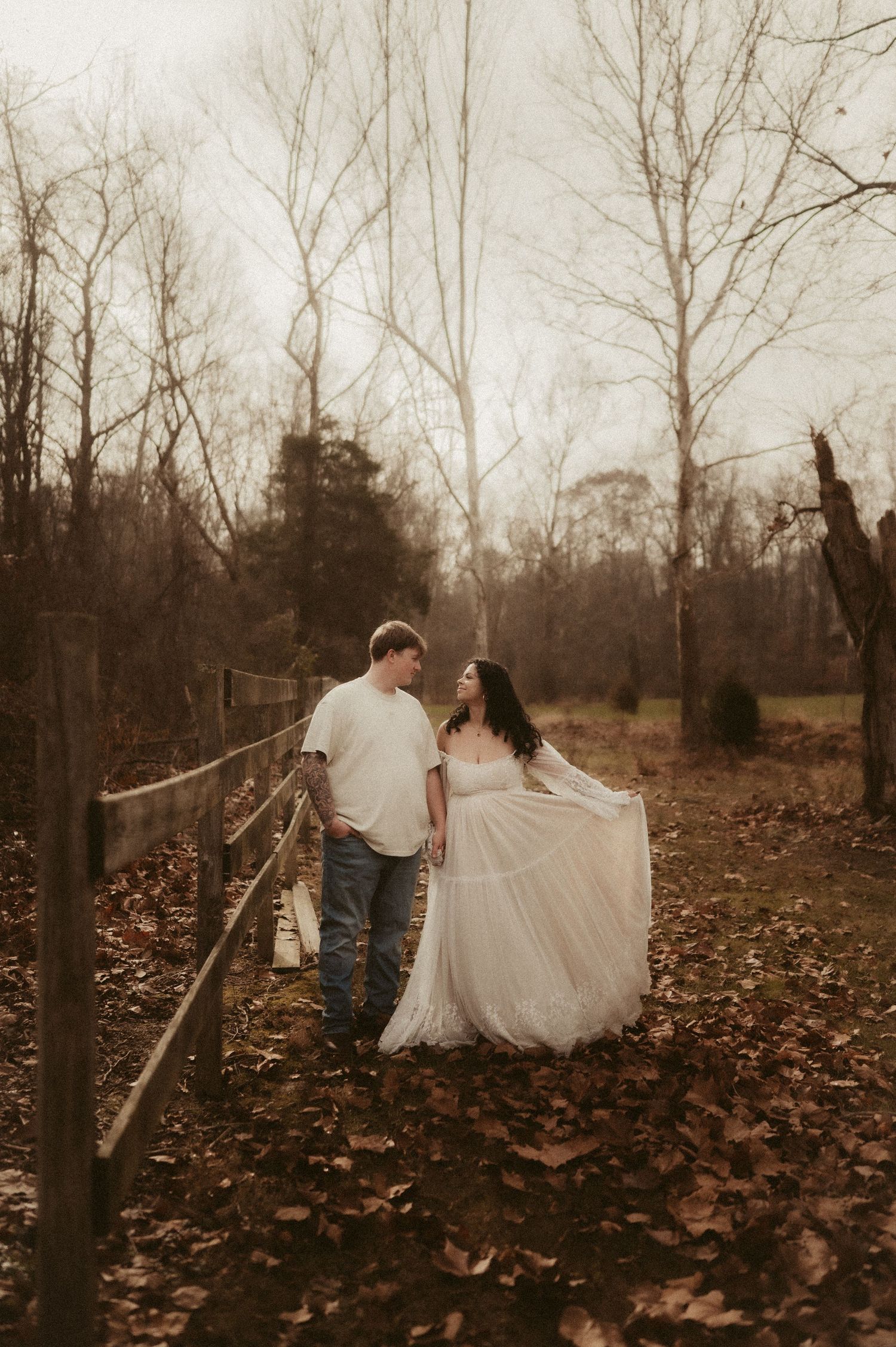 Indiana Couples Storytelling Photographer // Ethereal fall portrait with couple walking through fallen leaves and bare trees.