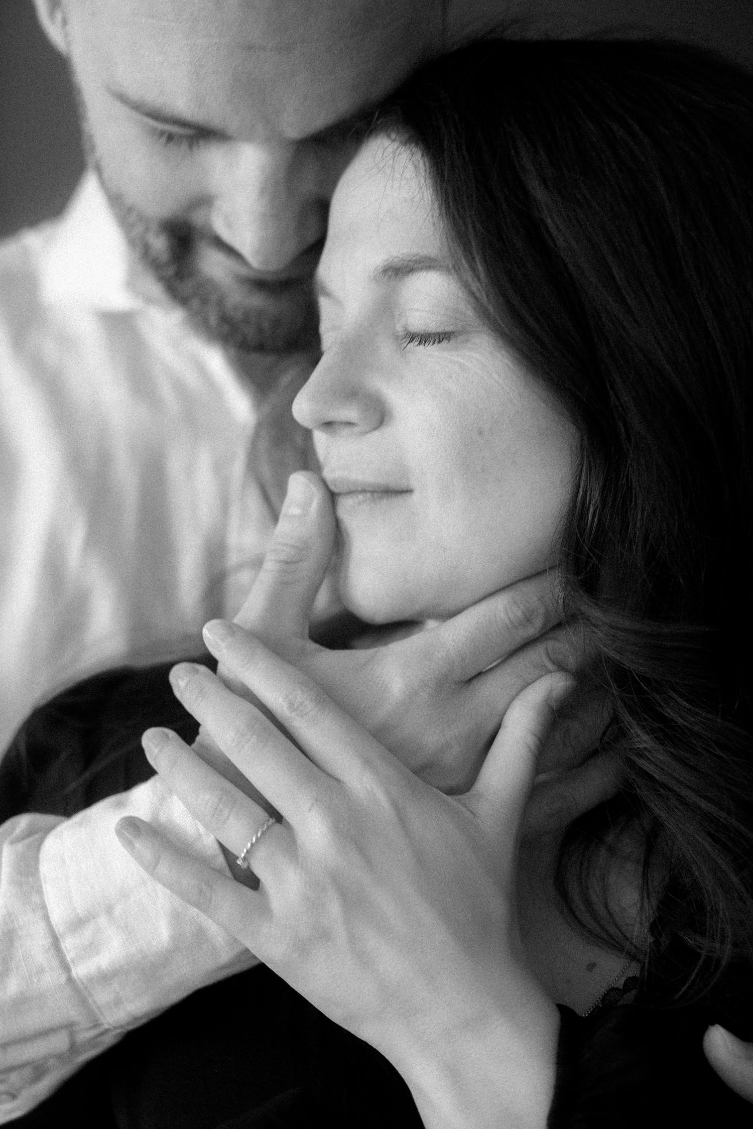 A romantic black and white photo series showing intimate close-up moments between a couple.