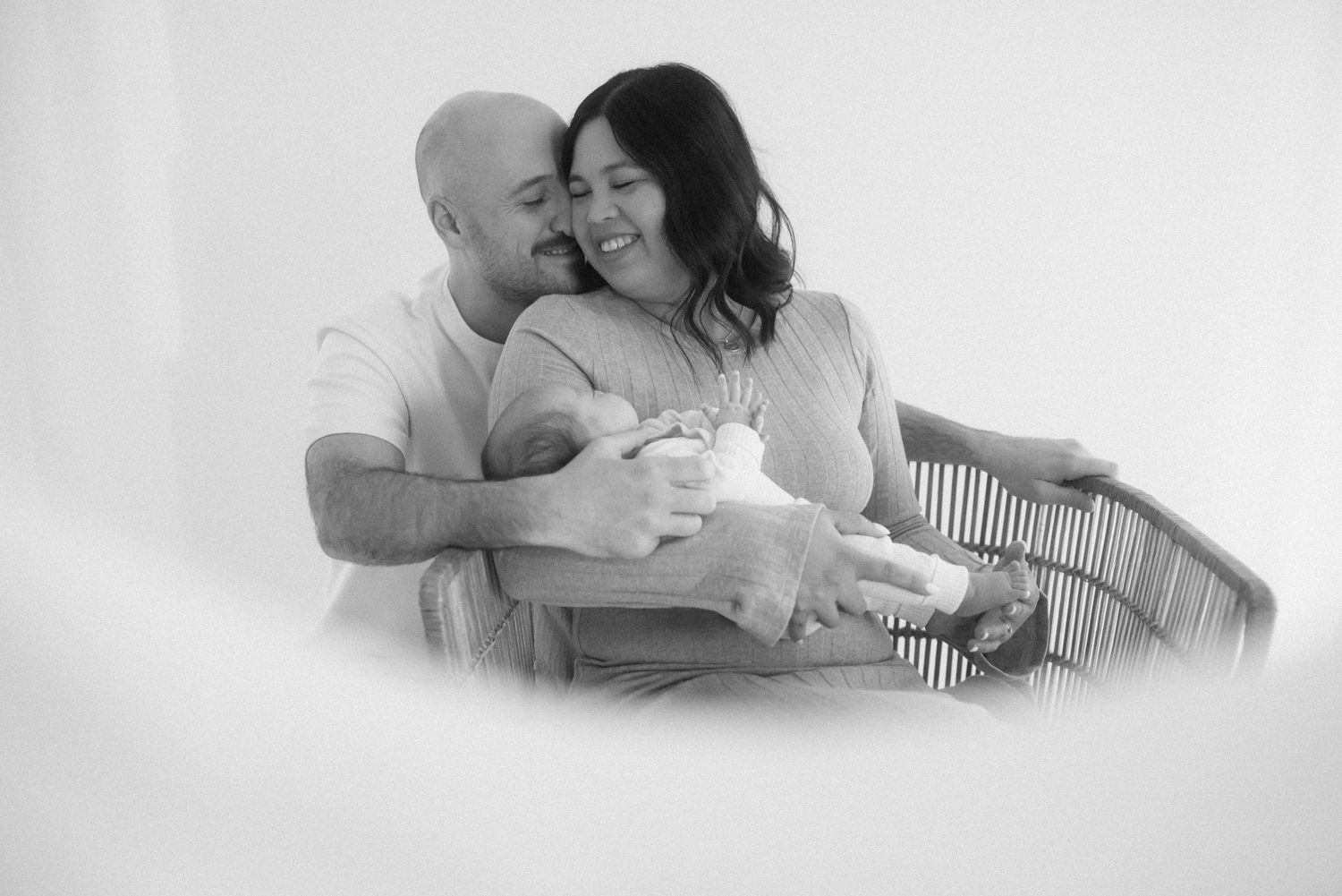 Artistic black and white series capturing loving family moments on white background.