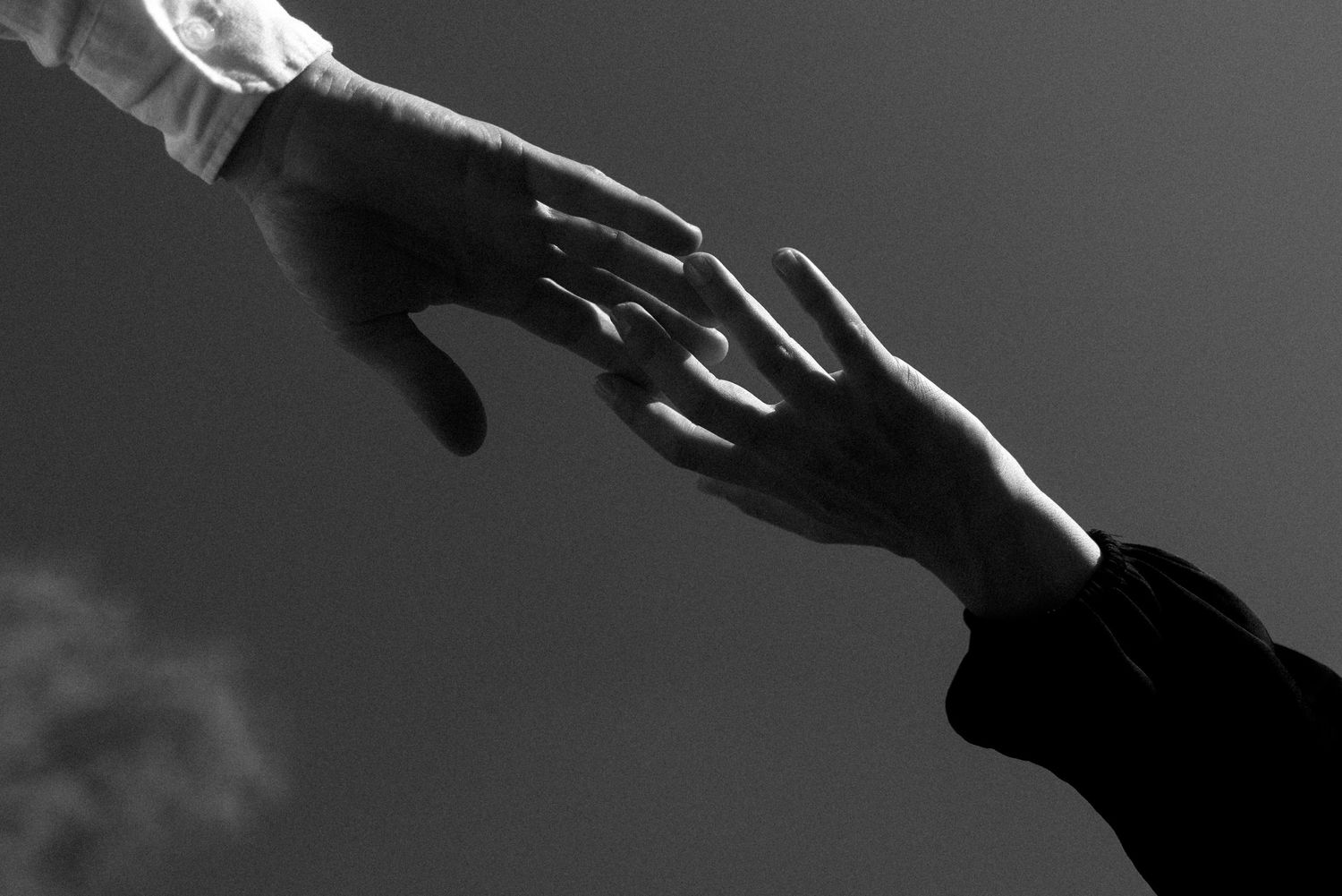 Abstract black and white close-up shots of hands and shadows.