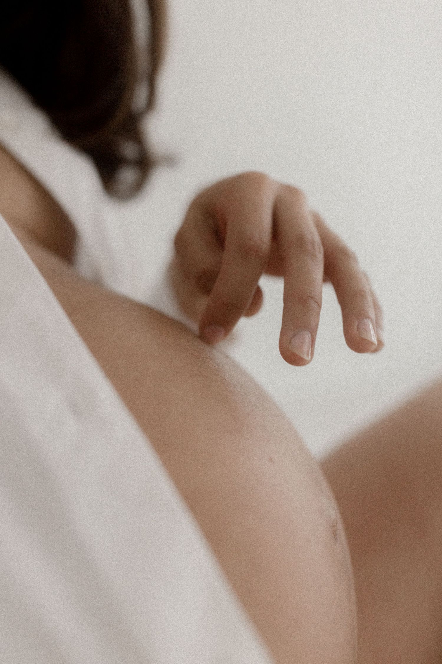 Abstract composition of outstretched hands against white backdrop.