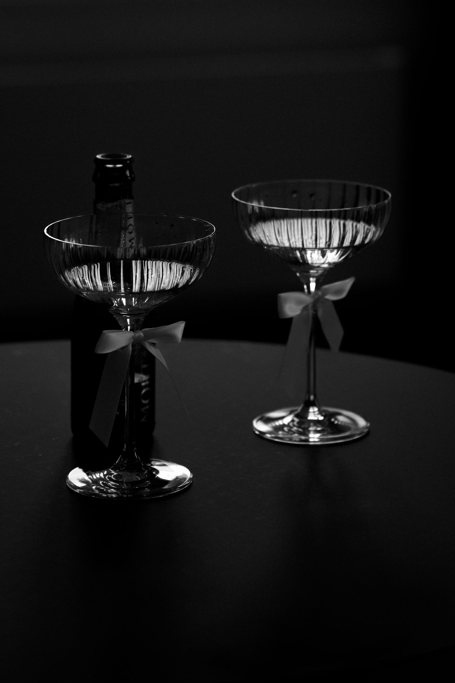 Dramatic lighting on crystal glassware creating geometric shadows in a dark setting at Hotel Montana Luzern.