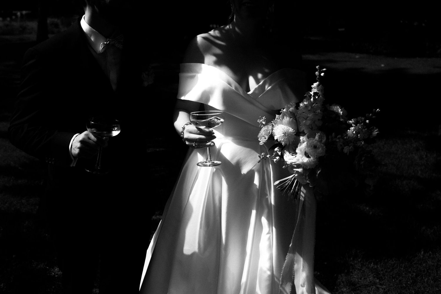 Black and white photograph of elegant wedding ceremony silhouettes against dramatic lighting at Schloss Hünenberg.