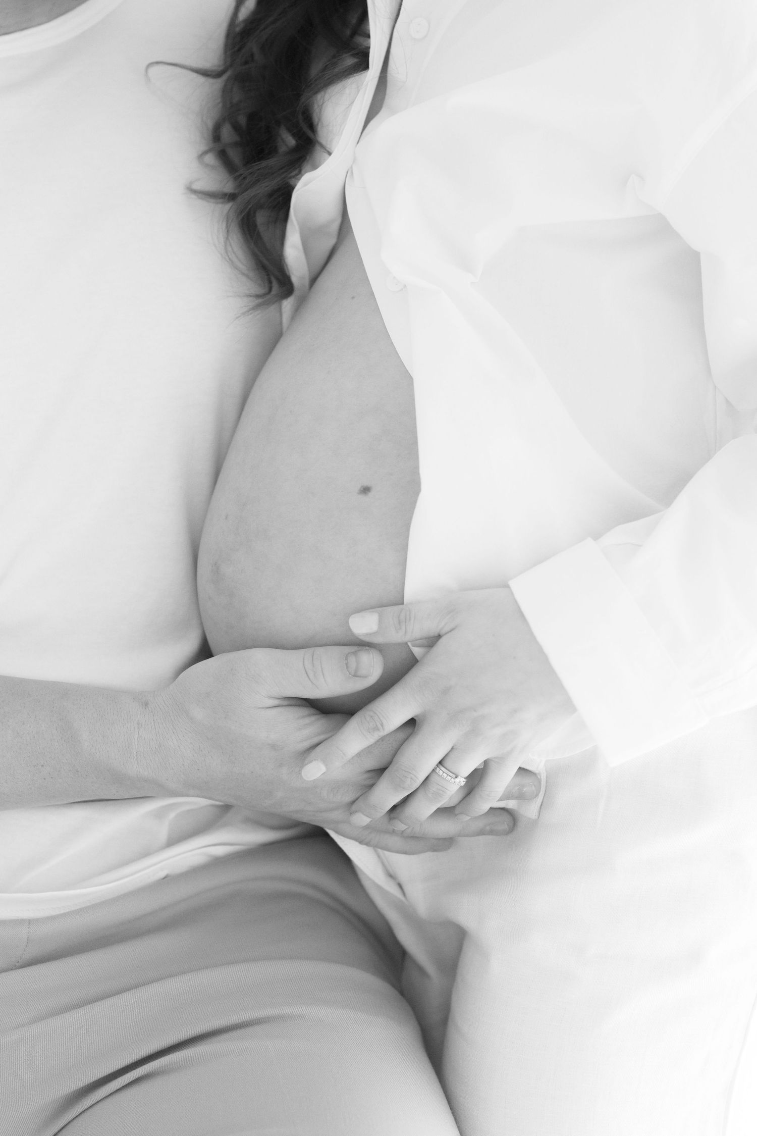 Soft monochrome maternity photos capturing tender moments with the baby bump.