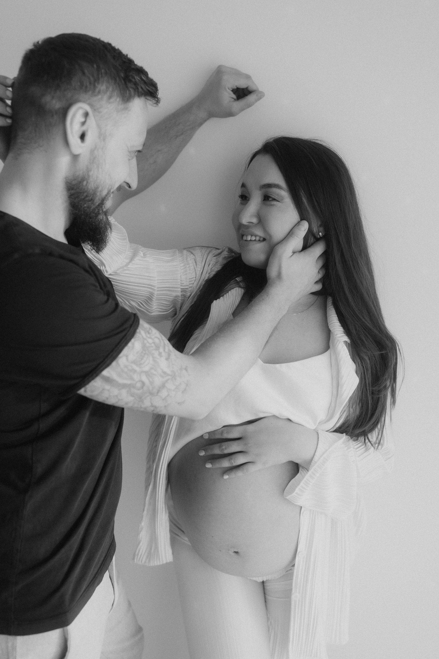 Intimate black and white portrait series against light background showing tender moments.