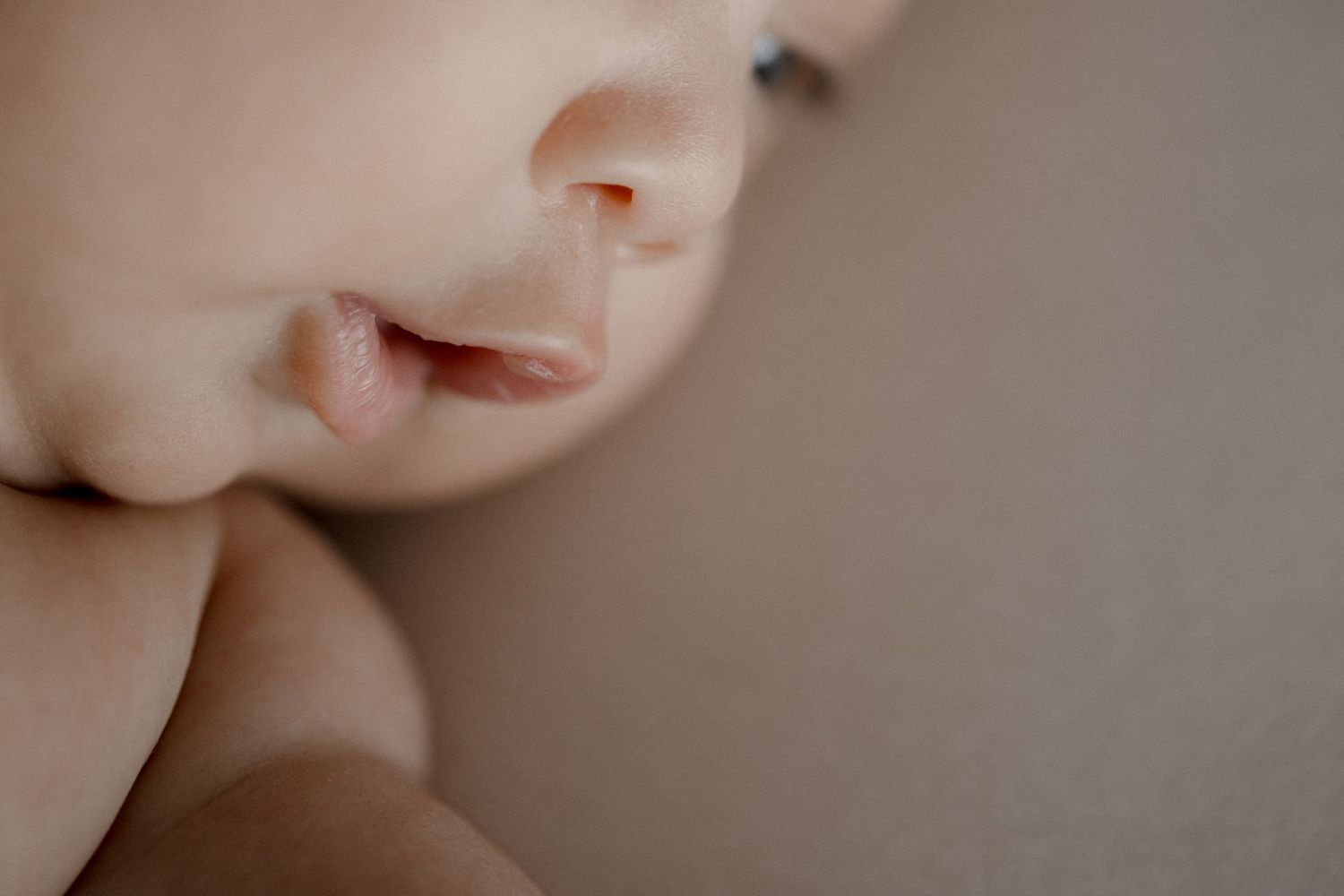 Artistic close-up portrait showing soft skin tones and gentle features.