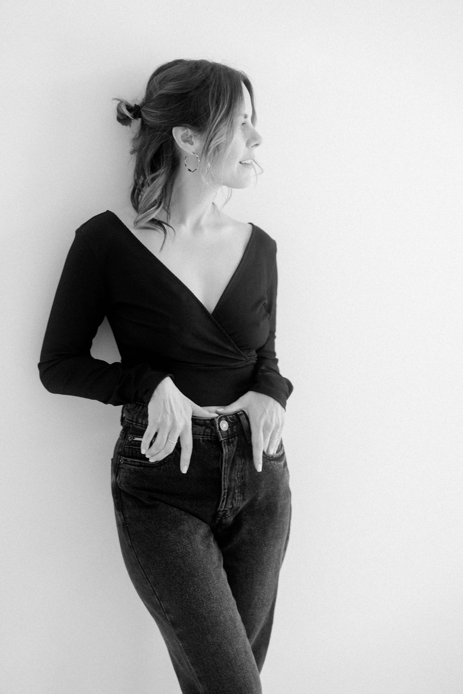 Black and white photo series showing a person in dark clothing posing expressively against a white background.