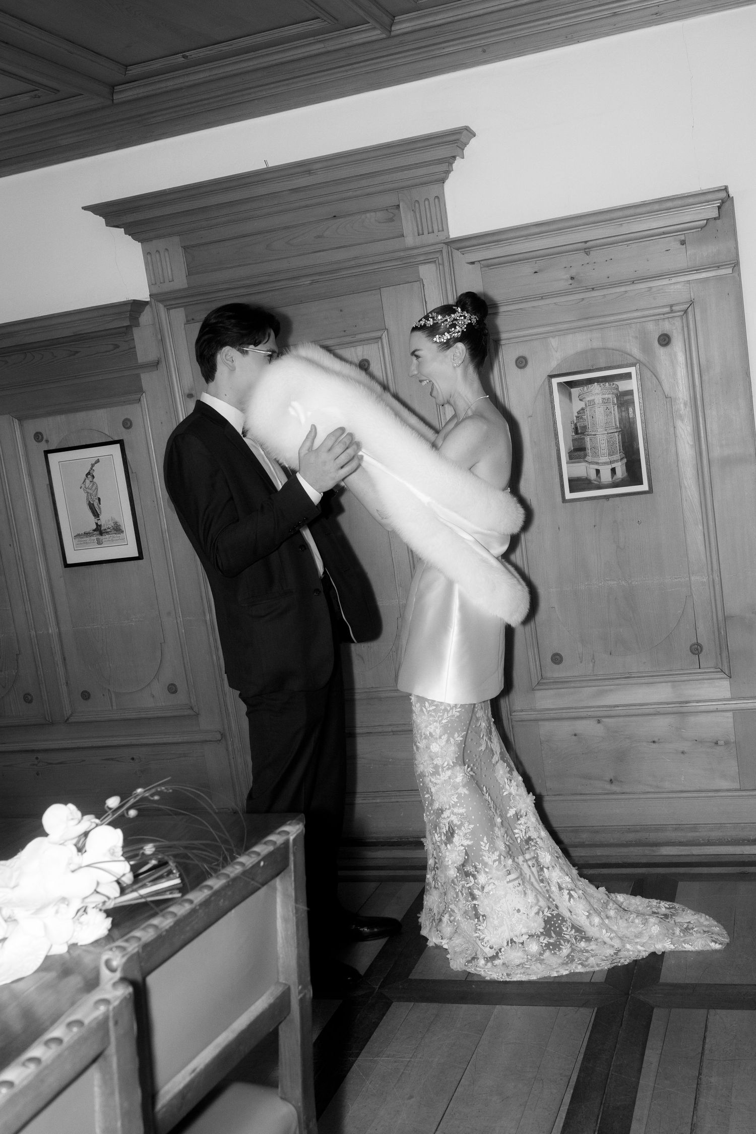 A sequence of black and white photos showing a couple playfully pillow fighting in what appears to be a bedroom.