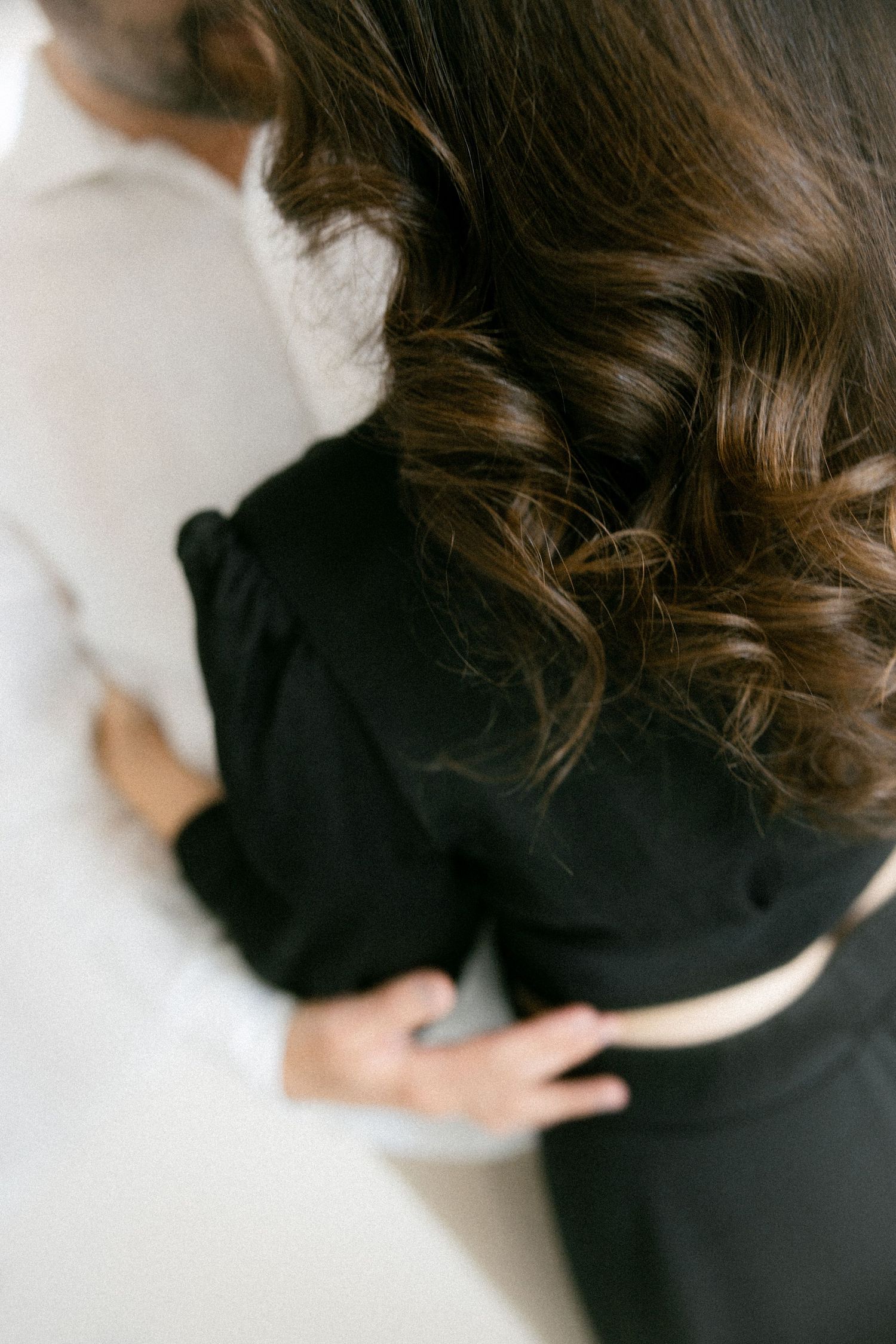 A series of cropped photos showing a person wearing a black shirt with brown wavy hair against a white background.