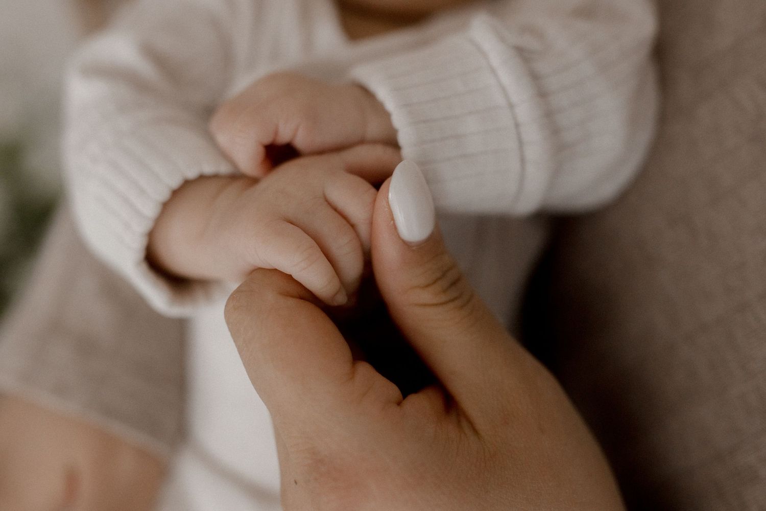 Close-up details of gentle hands and tender touches in warm tones.