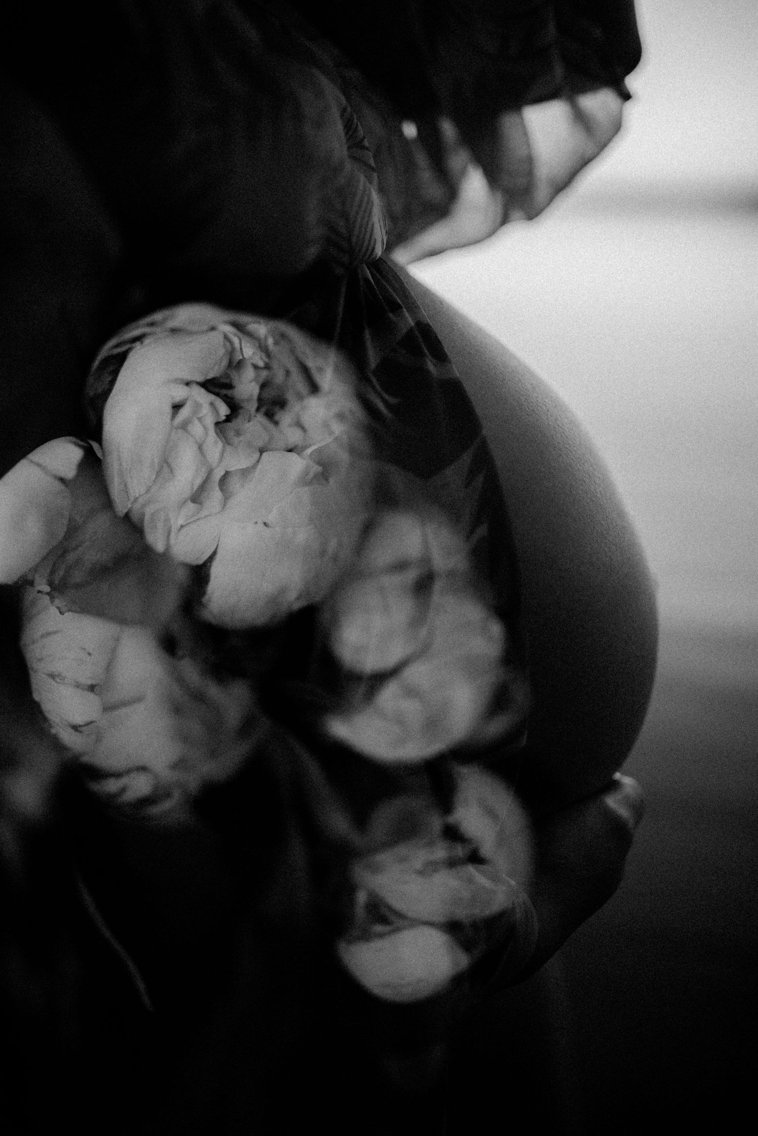 Moody black and white close-up shots of flowers creating an artistic gradient effect.