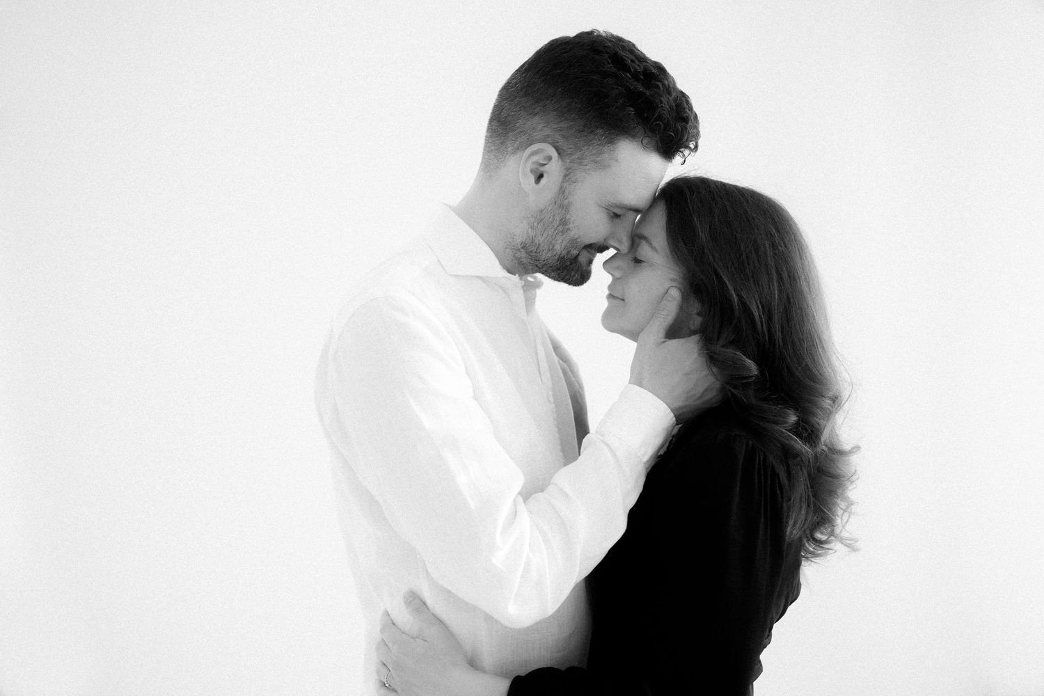 A romantic black and white photo series showing intimate moments between a couple in three tender poses.