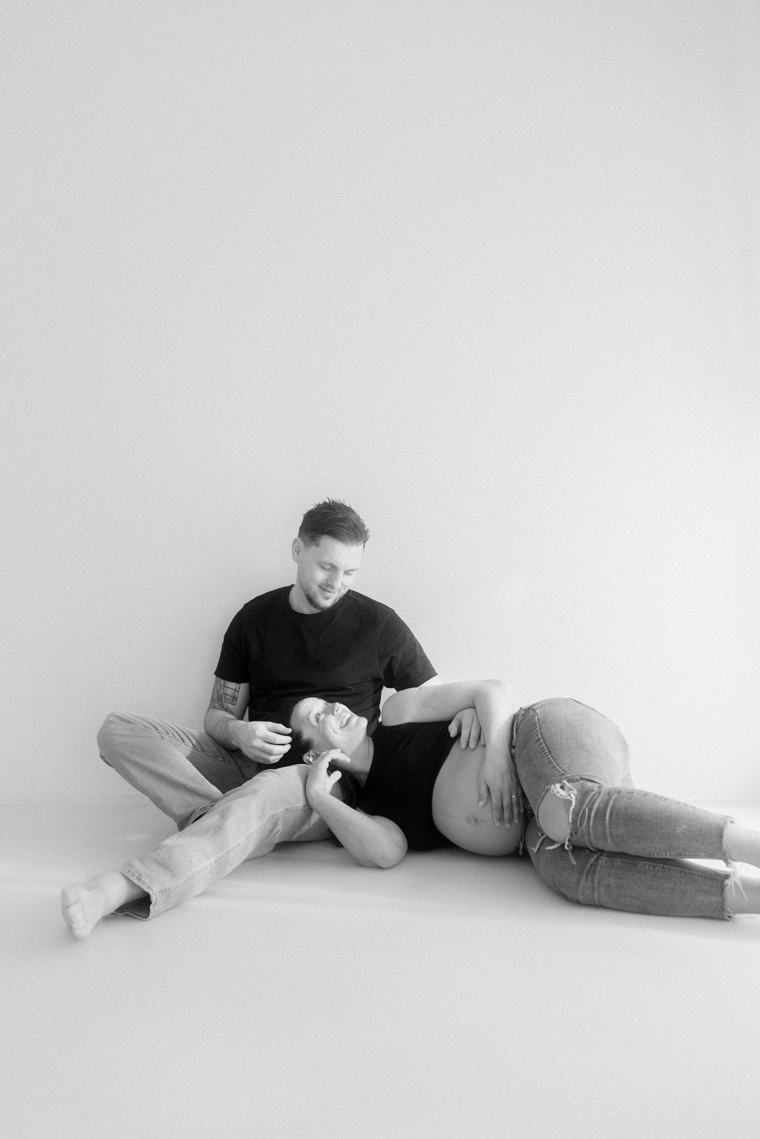 Series of minimalist black and white photos showing a person resting on the floor in various poses.