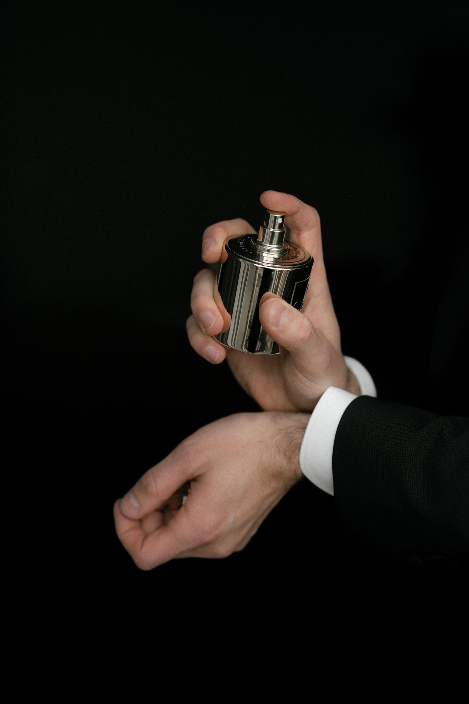 Hands in formal attire adjusting cufflinks against a dark background at Montana Luzern.