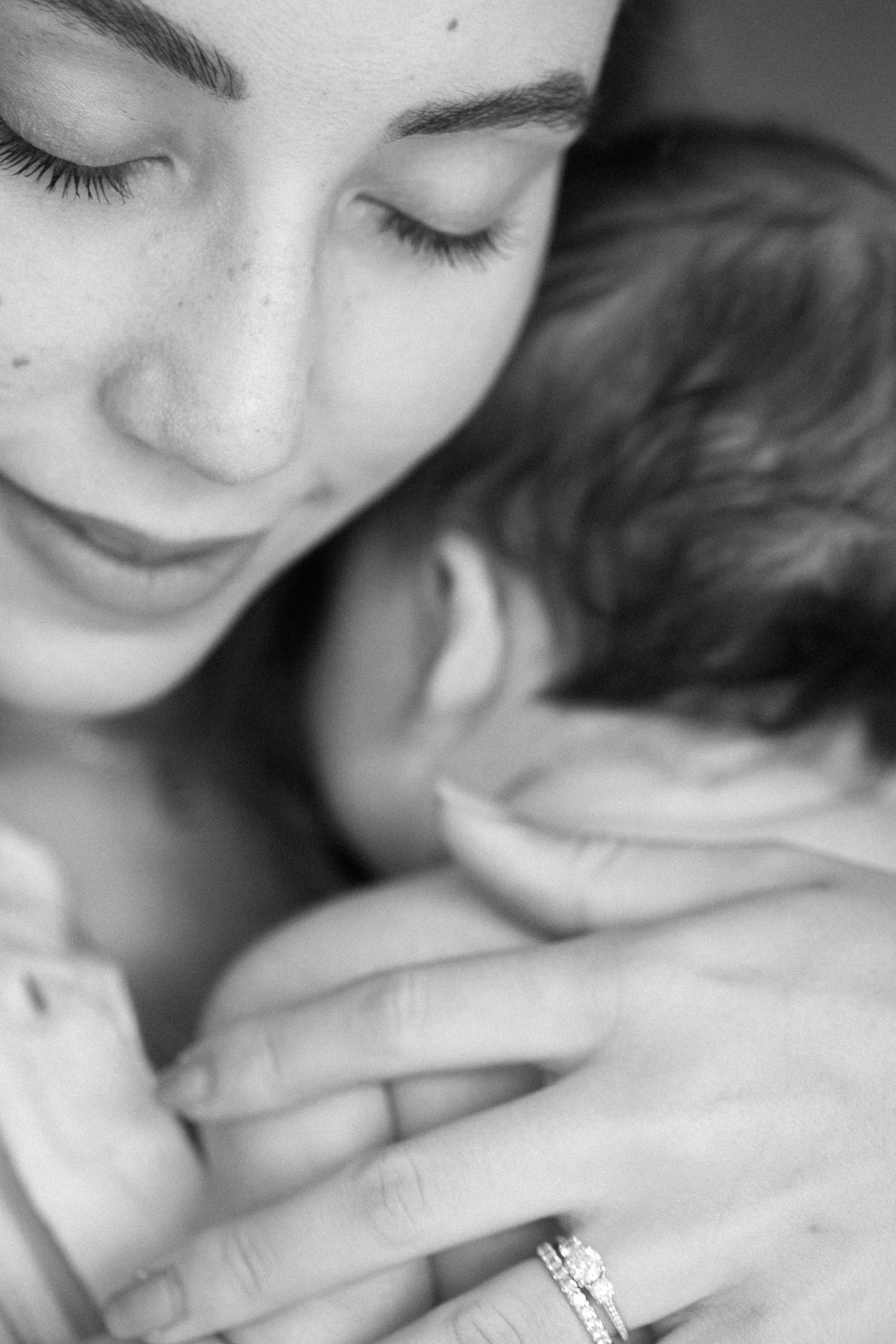 Intimate close-up black and white portrait showing gentle expressions.
