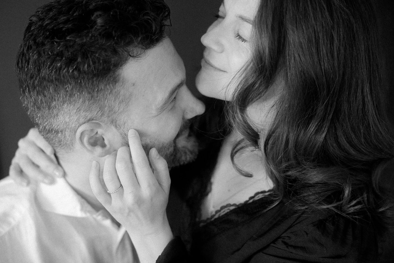A romantic black and white photo series showing intimate moments between a couple kissing and embracing.