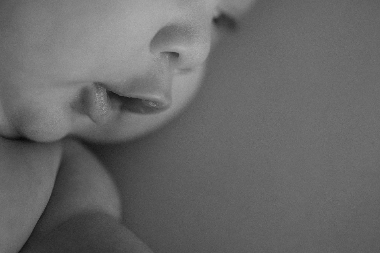 Intimate black and white close-up photography showcasing gentle interaction.