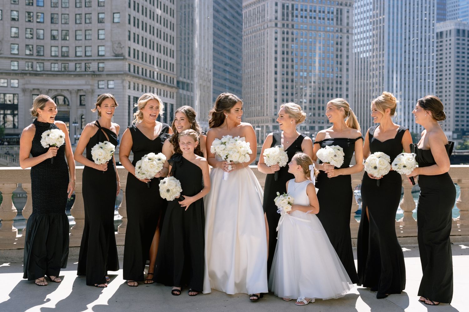 Bride and bridesmaids with beautiful bouquets on Chicago Riverwalk in downtown, captured by Chicago documentary luxury wedding photographer.