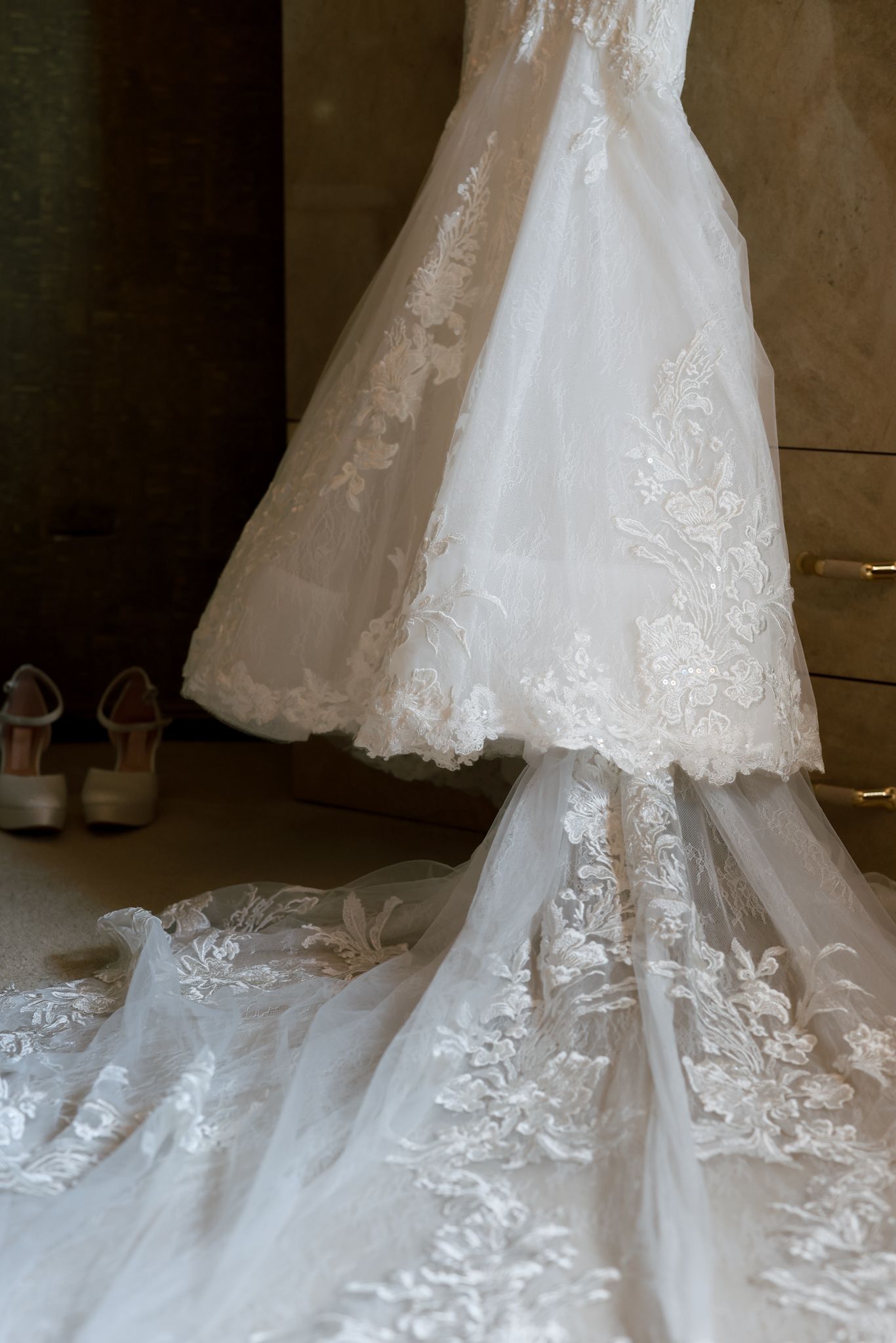 Lace bridal dress hanging in elegant detail, expertly photographed by a luxury Chicago wedding photographer specializing in wedding days.