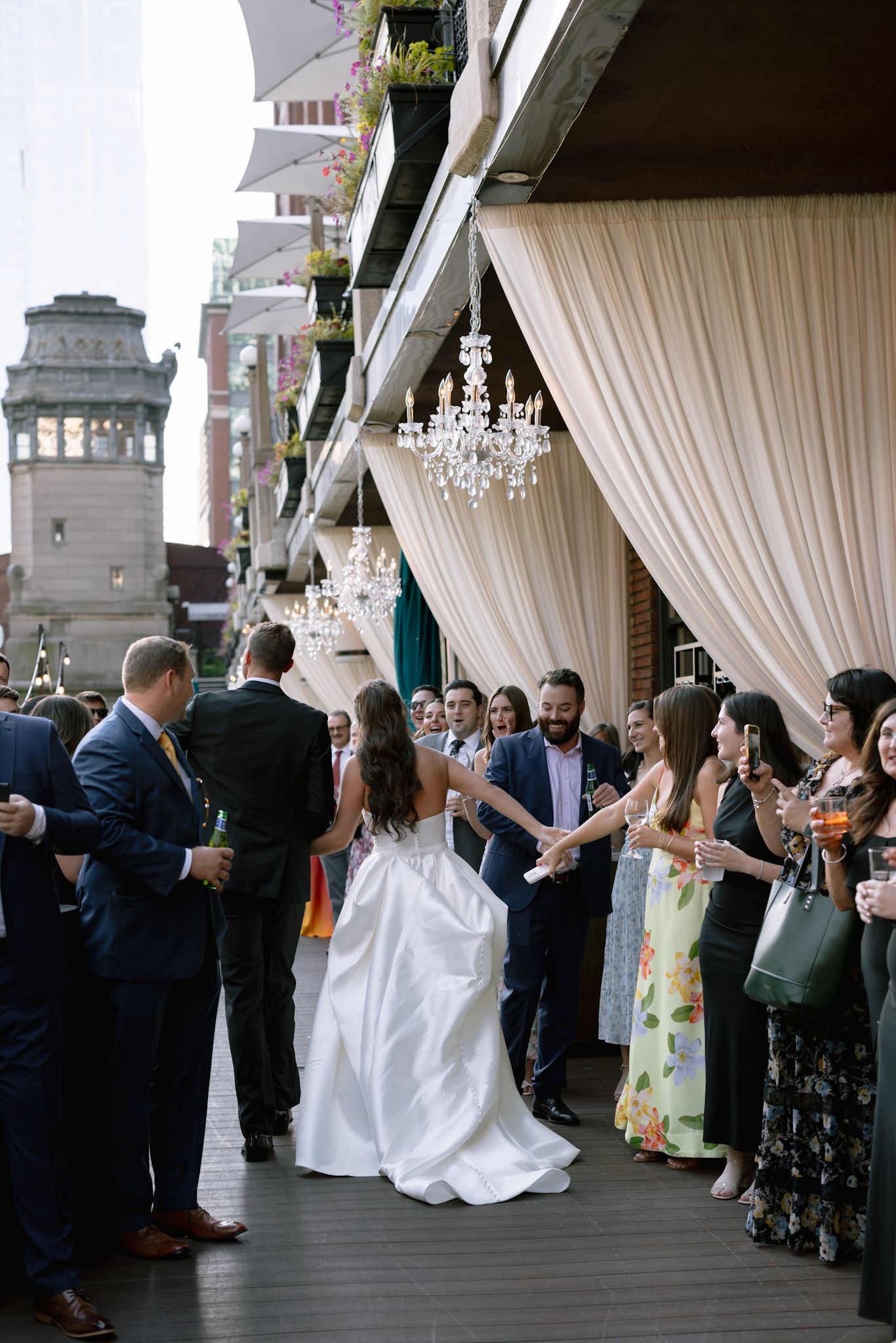 Bride and groom with guests during River Roast cocktail hour, captured in luxury editorial and documentary style by Chicago photographer.