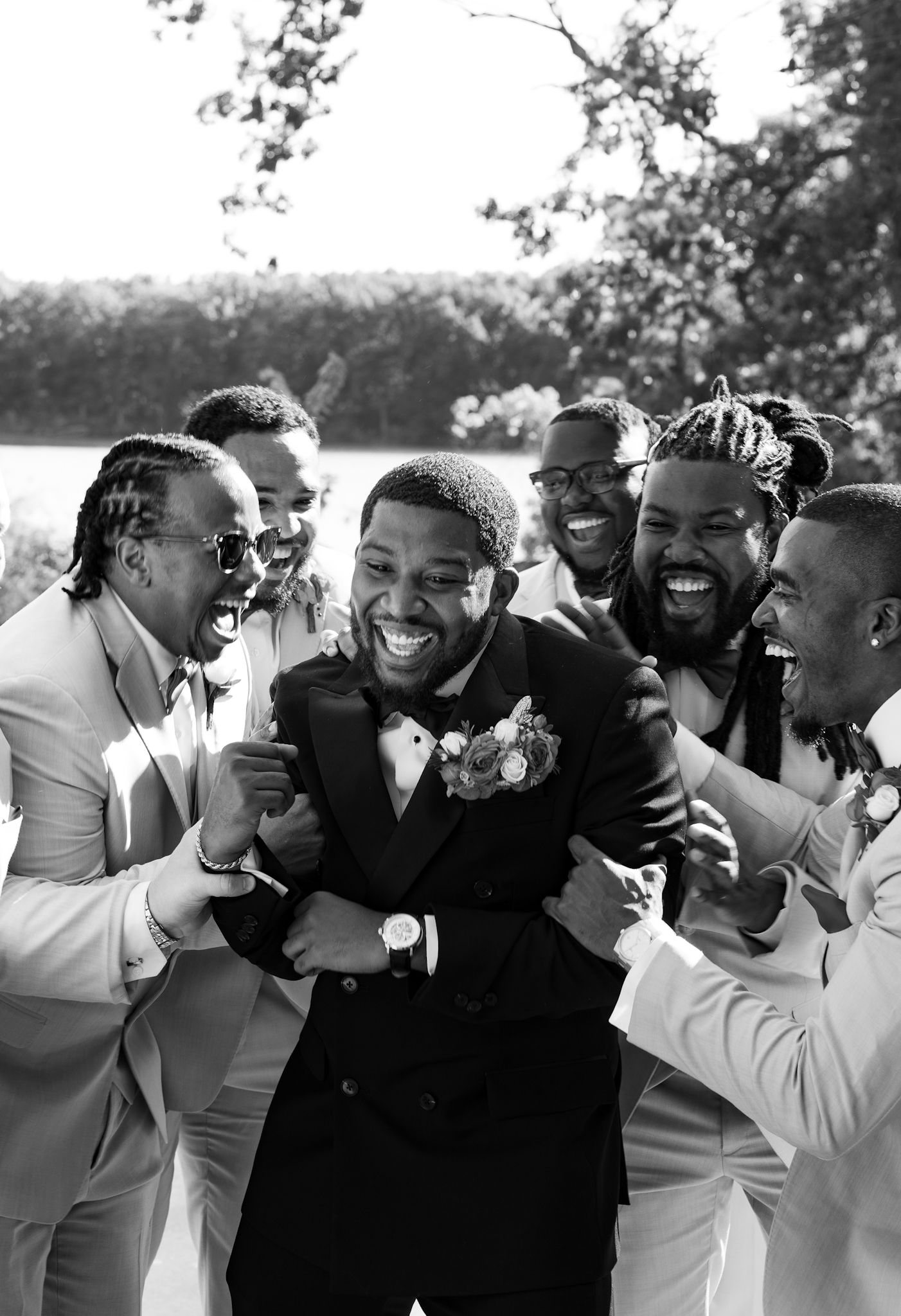 Groom having fun with groomsmen, captured by luxury Chicago wedding photographer in documentary and editorial style for high-end weddings.